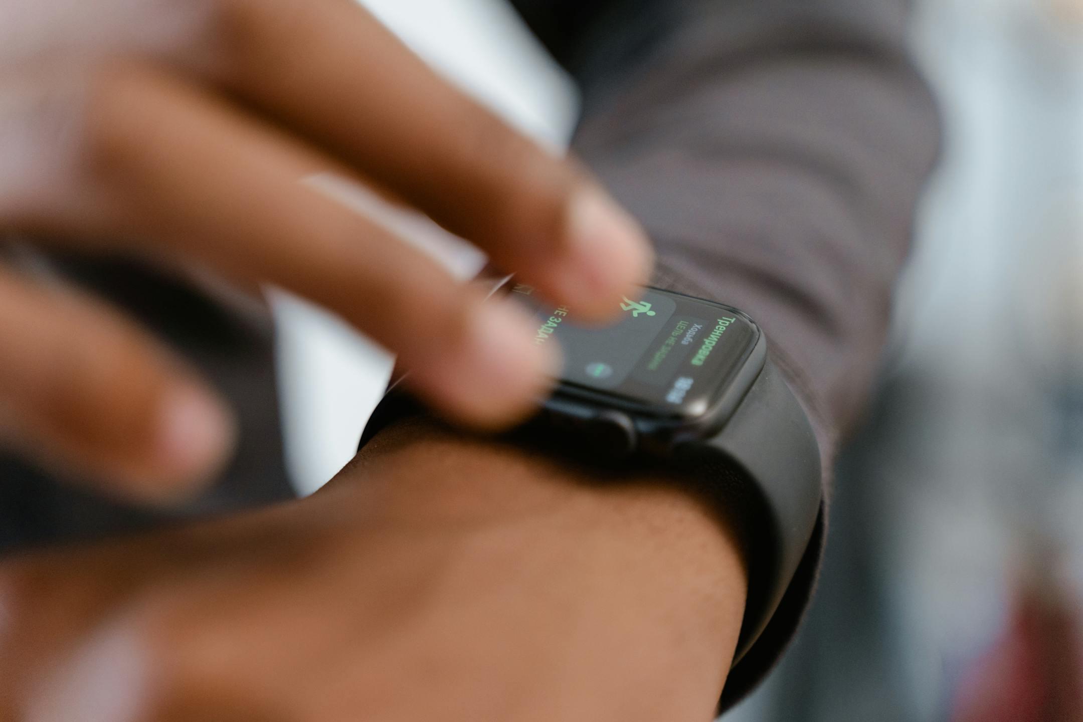 A detailed image showing a person interacting with a smartwatch, highlighting fitness tracking capabilities.