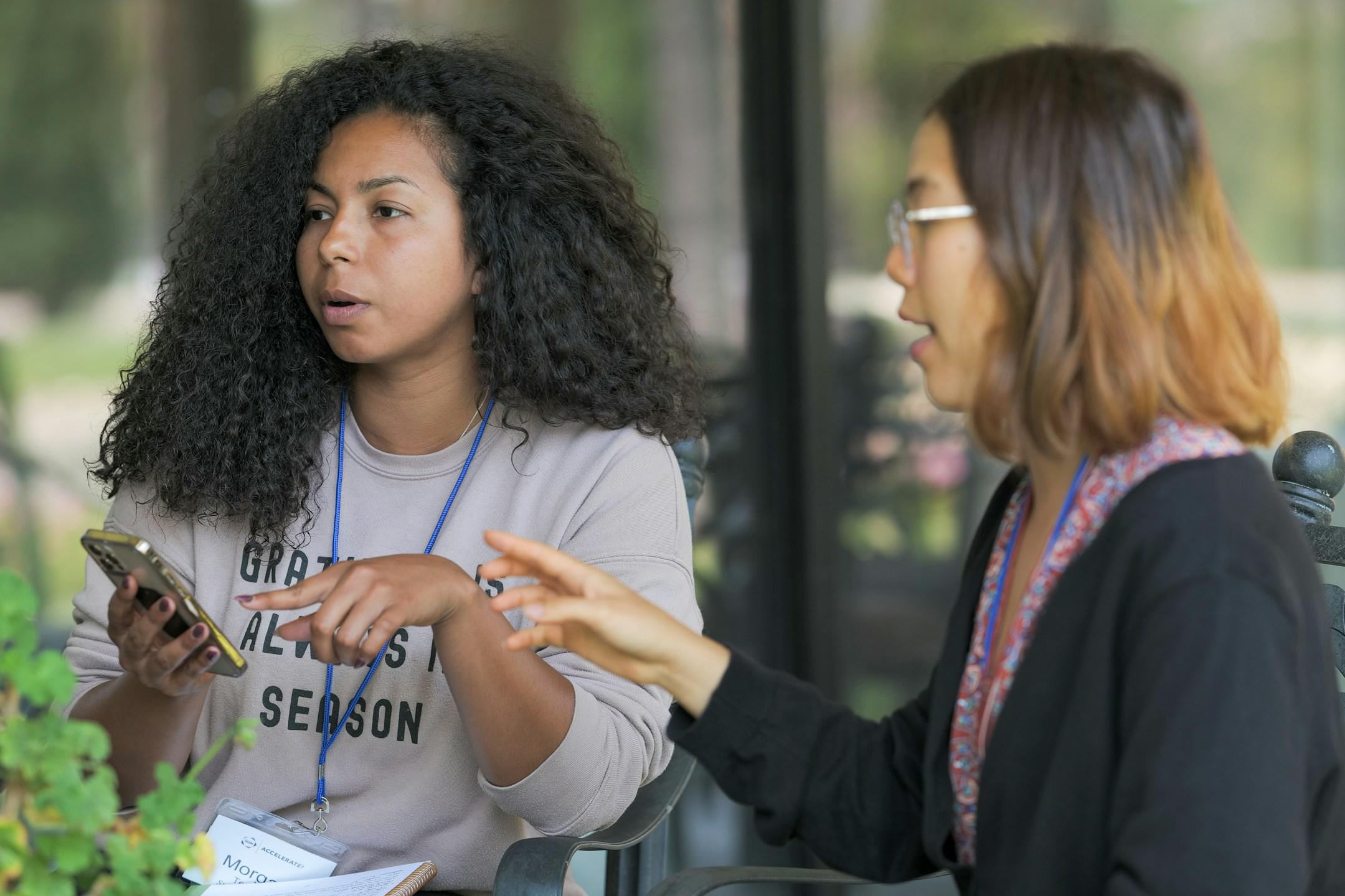Two women discussing a sermon in their small group.