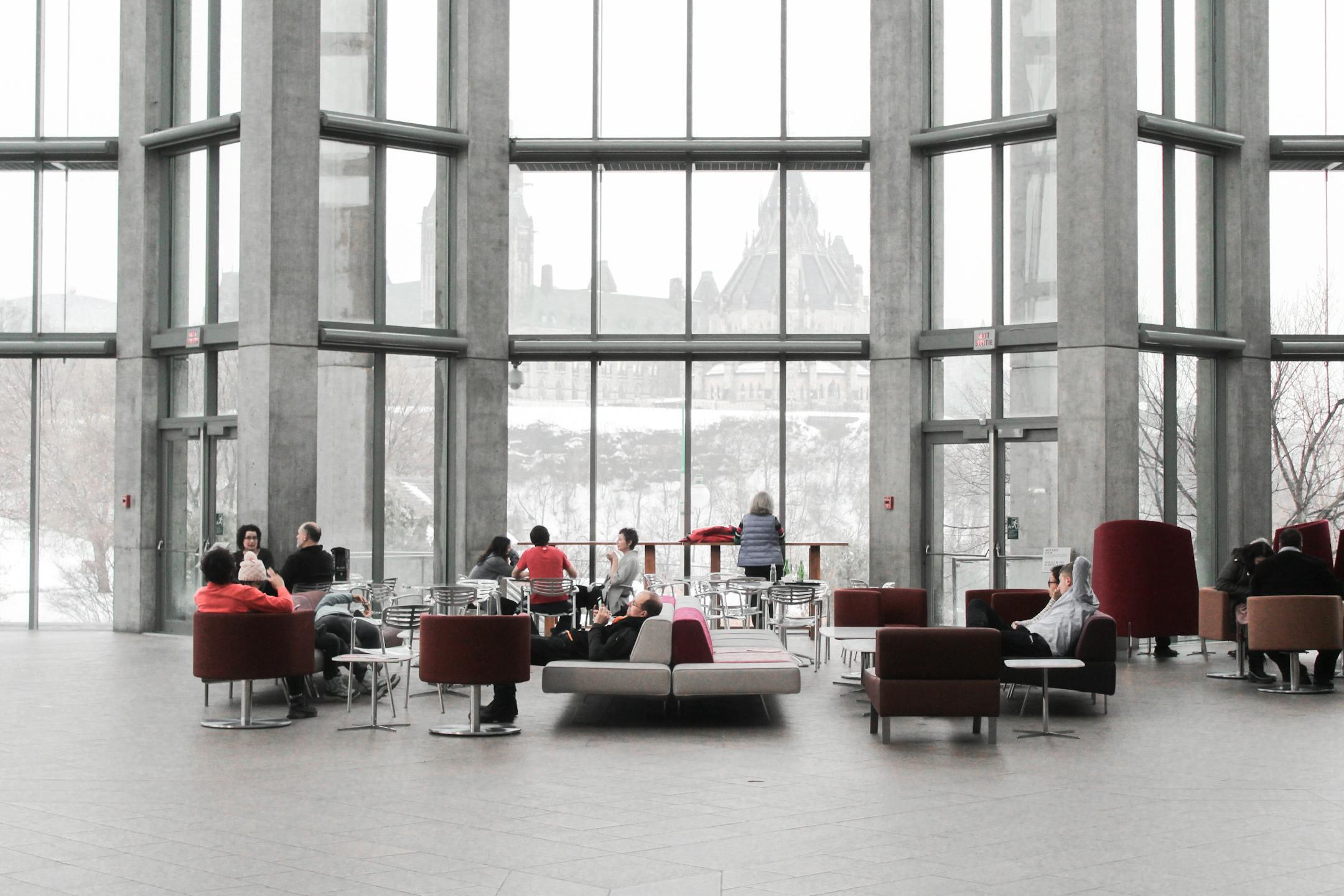 Spacious lounge with modern decor and large windows showcasing a snowy Ottawa view.