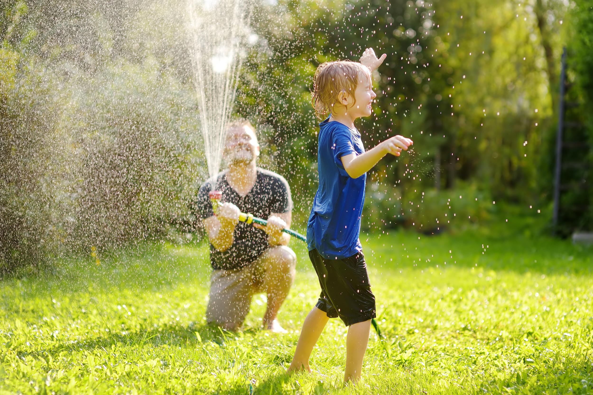 boy-playing-with-water-sprinkler-with-adult-2026-09-21-21-23-32-utc.jpg