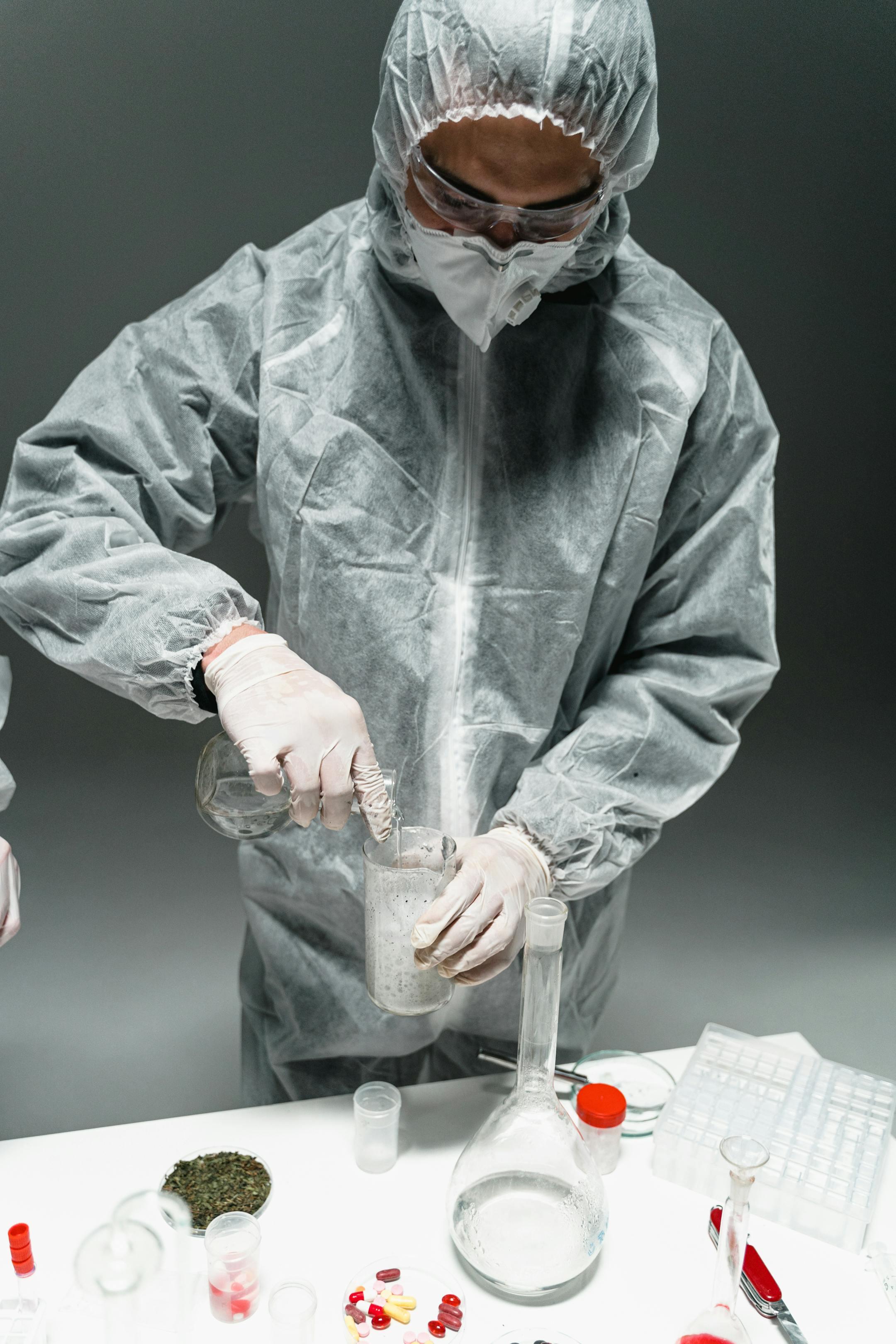 Researcher in protective suit experimenting with chemicals in a laboratory setting.