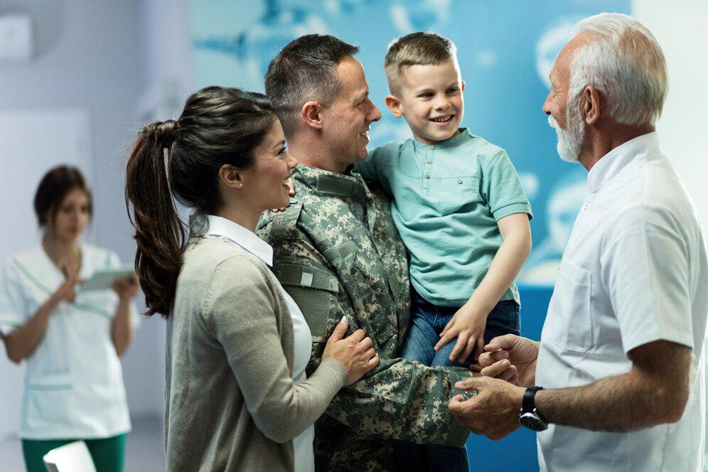 happy-senior-doctor-talking-little-boy-who-came-with-mother-military-father-clinic-focus-is-military-man_637285-552.jpg