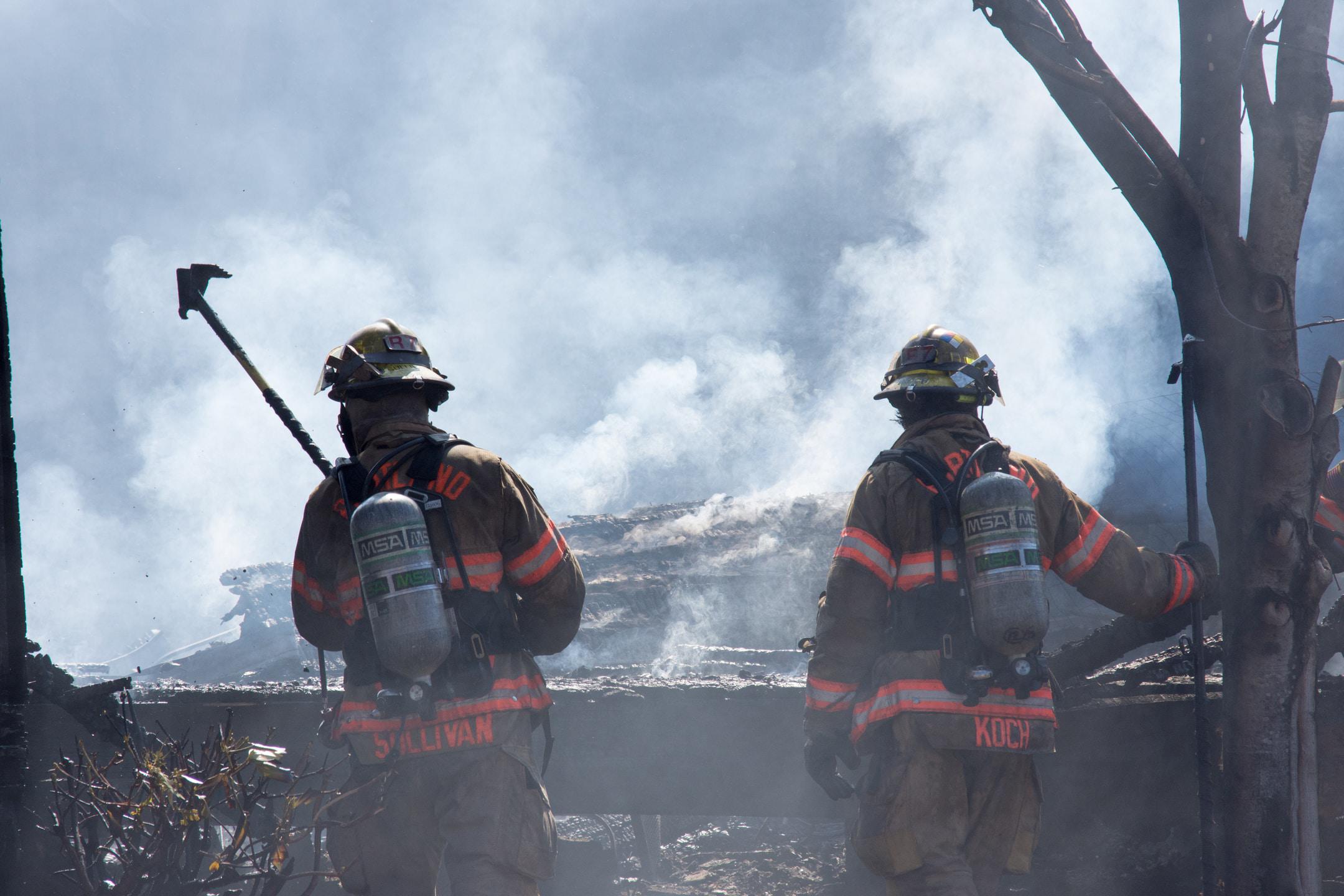 In this photo, I captured a photo of firefighters attacking embers in a structure fire that was suspected to be arson. The smoke and heat were very intense that day and the firefighters worked diligently to bring an end to the fire that consumed two structures.