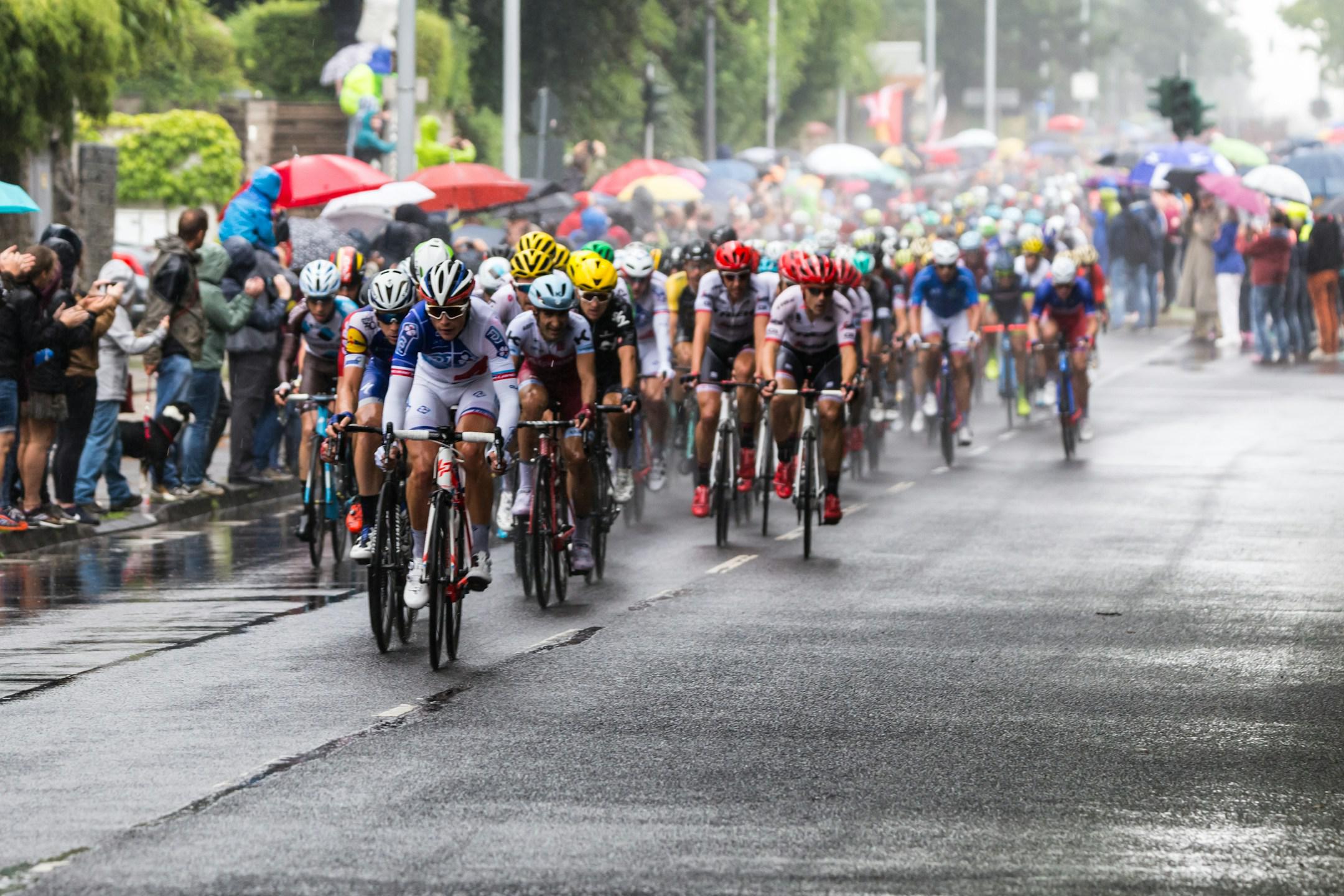 Tour de France peloton in rainy weather.