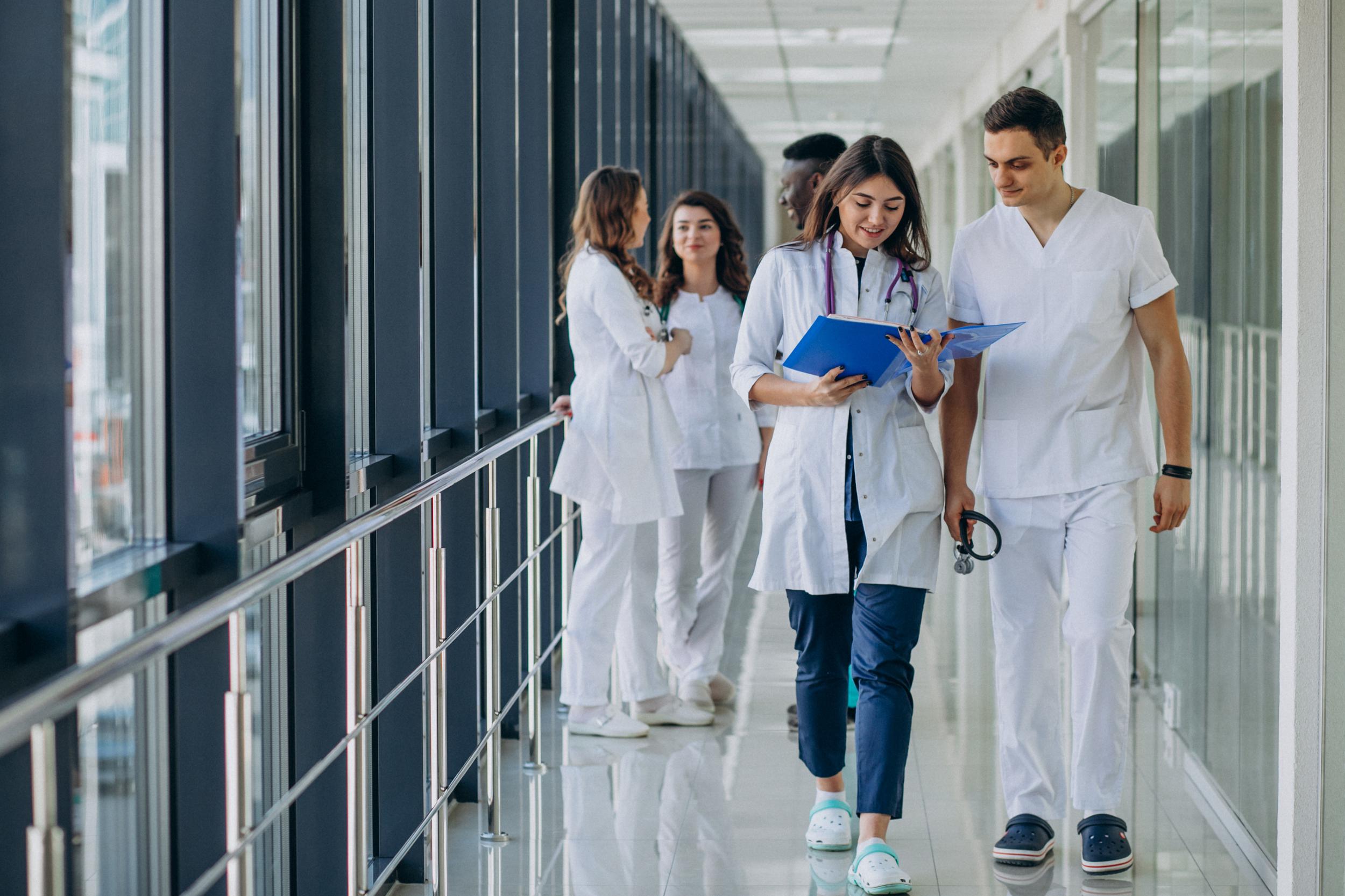 team-young-specialist-doctors-standing-corridor-hospital.jpeg