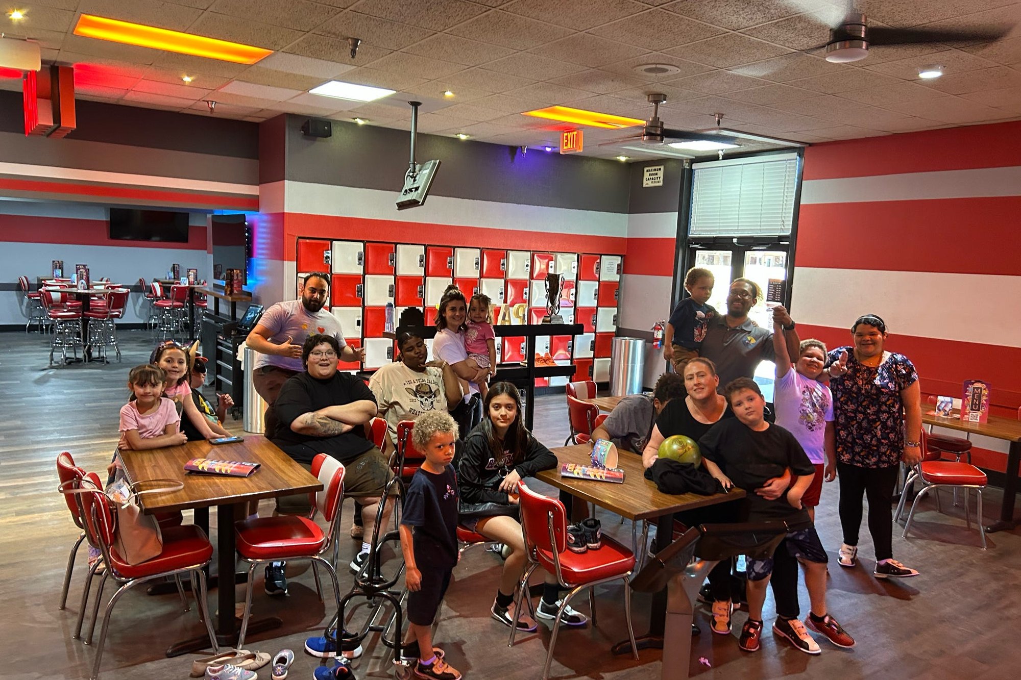 Families and children gathered at tables during a community event at Brighter View.