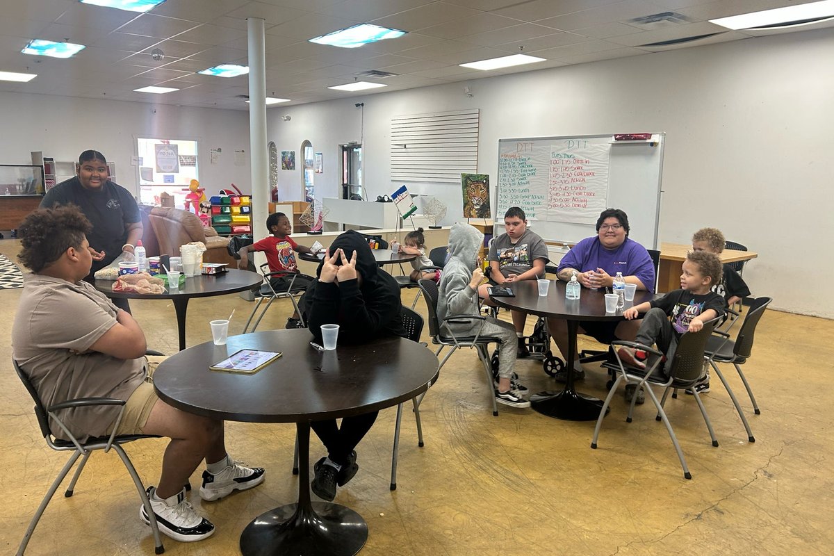 Participants and staff seated together in the day program room.