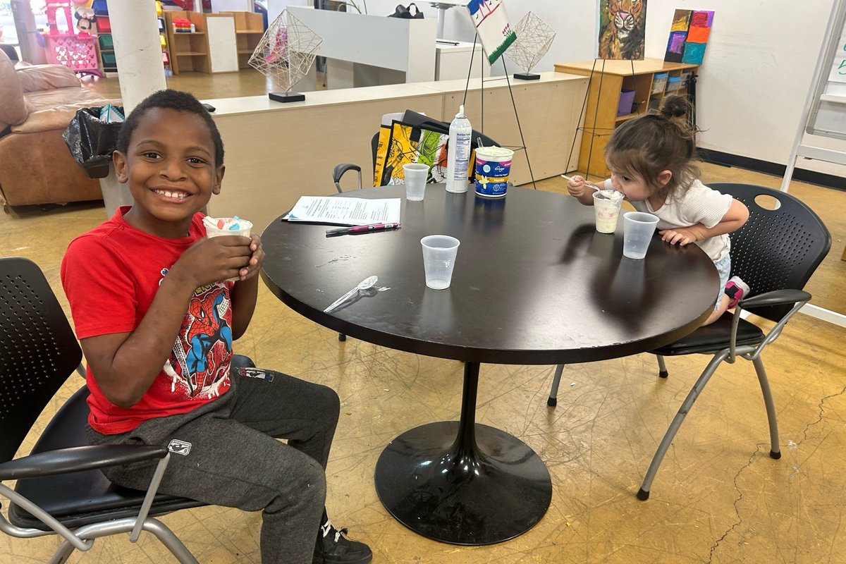 A participant smiling at a table in the day program room.