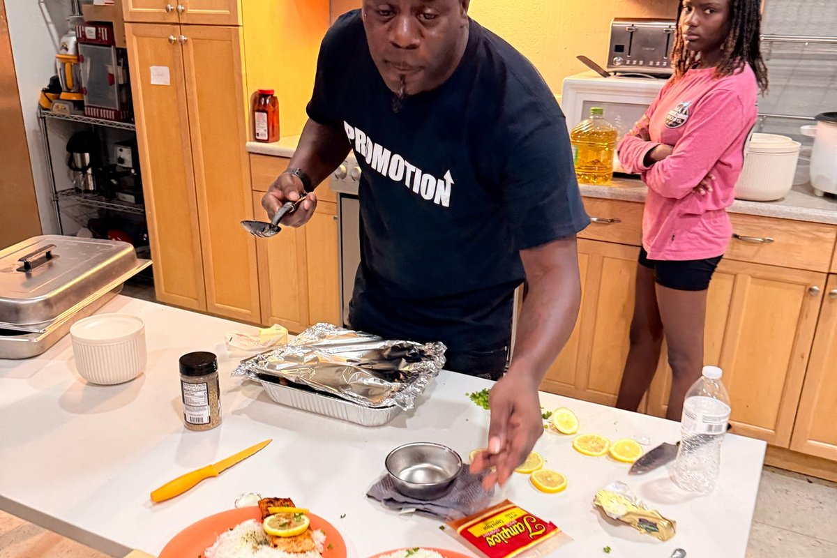A cook plating a hot meal in the Brighter View culinary kitchen.