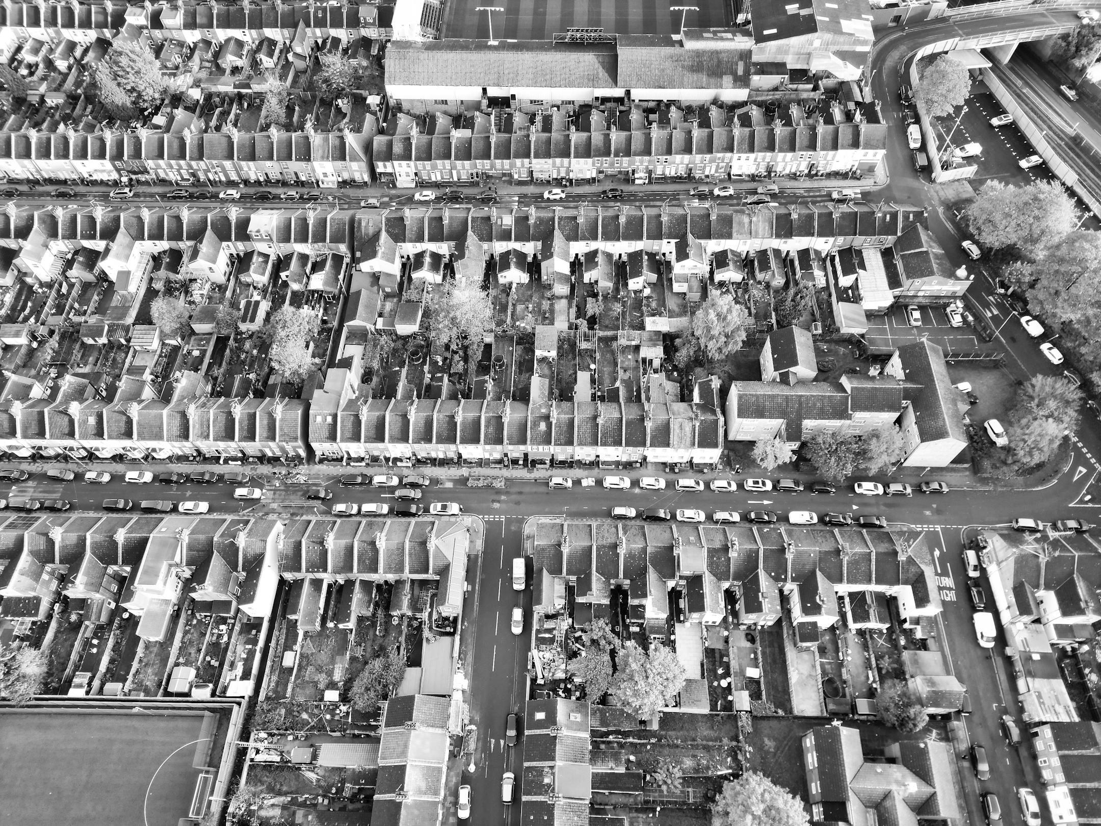 Black and white aerial view of urban residential rooftops in Luton, England.