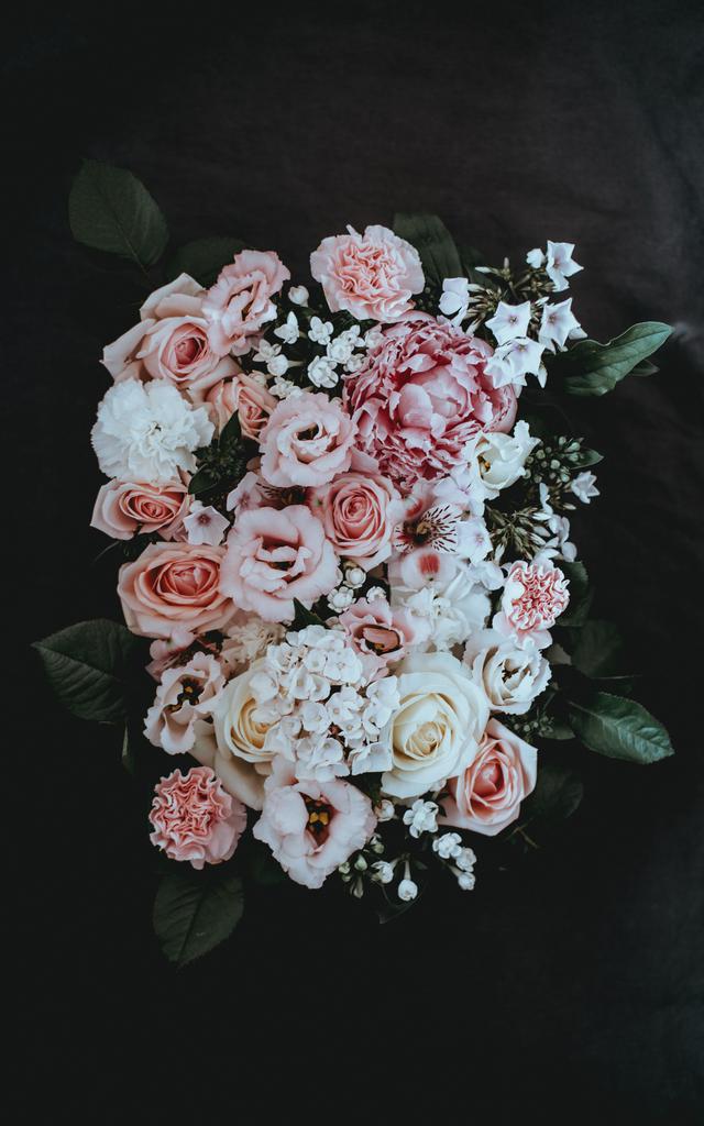 Pale pinks and whites arranged in a florists oasis, sat on top of a (very unglamorous) dark grey tshirt.
Part of a series of dark florals, you can find the rest on my Unsplash profile ❤️
