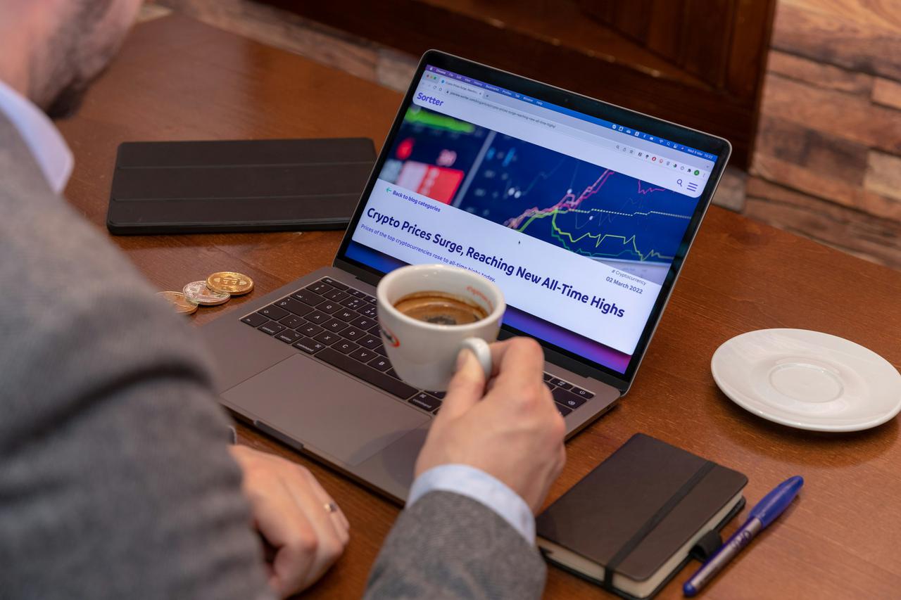 Sitting in a coffee shop checking crypto prices with some bitcoins aside.