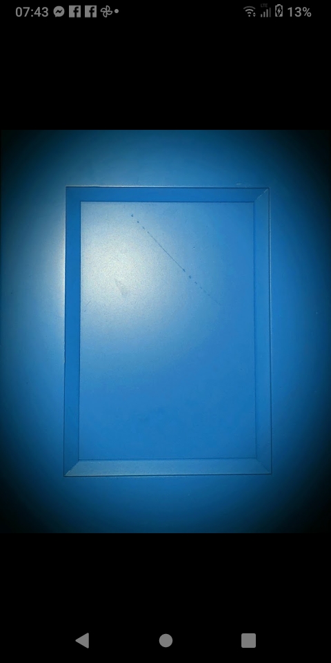 A framed window or opening with deep blue glowing light, surreal atmospheric composition