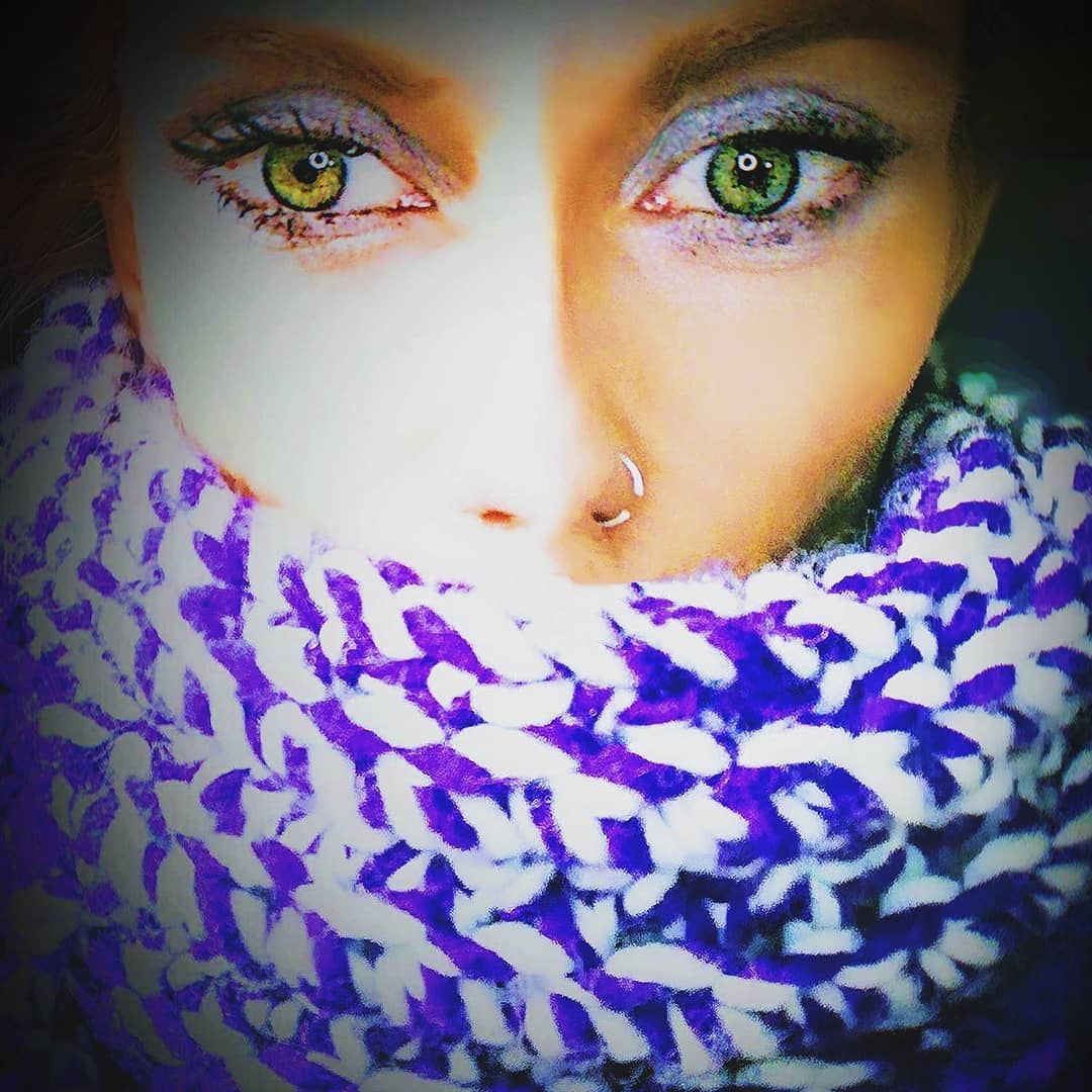 Close-up portrait of a young adult with heterochromia, one blue eye and one brown eye, calm direct gaze in soft window light