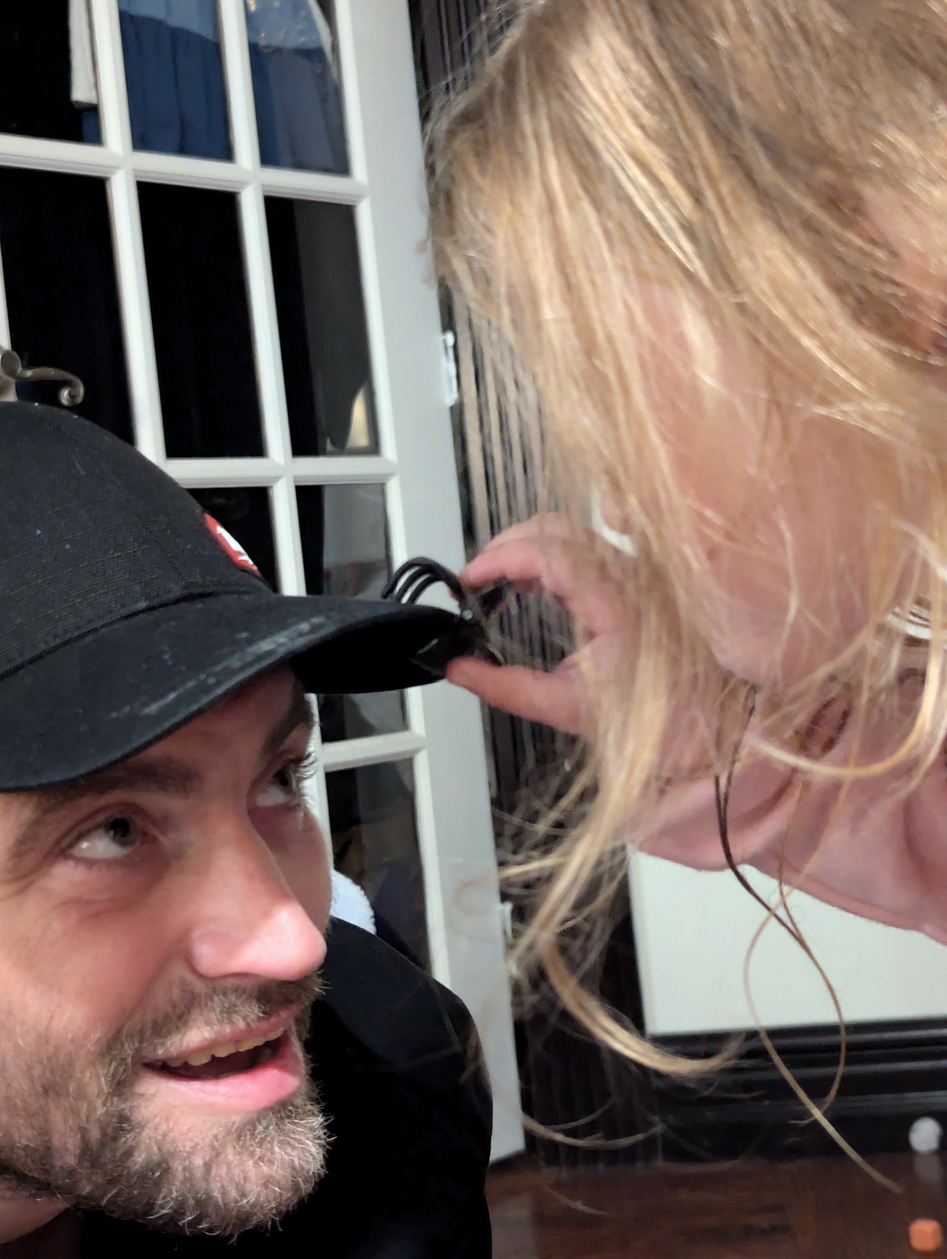 A humorous or candid portrait involving grooming, possibly with an unusual assistant or situation