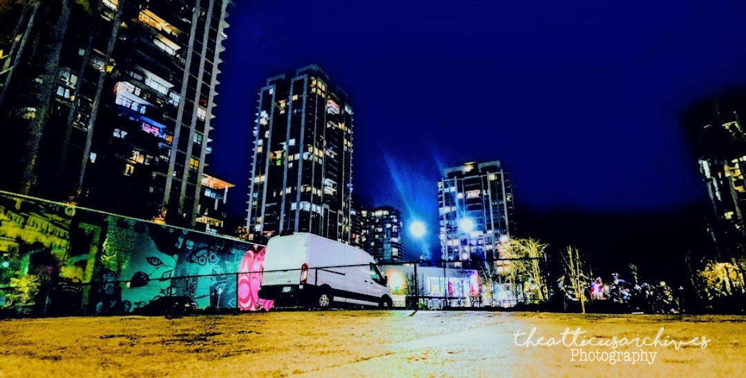 Urban nightscape with electric lights, neon glow, city infrastructure illuminated at night