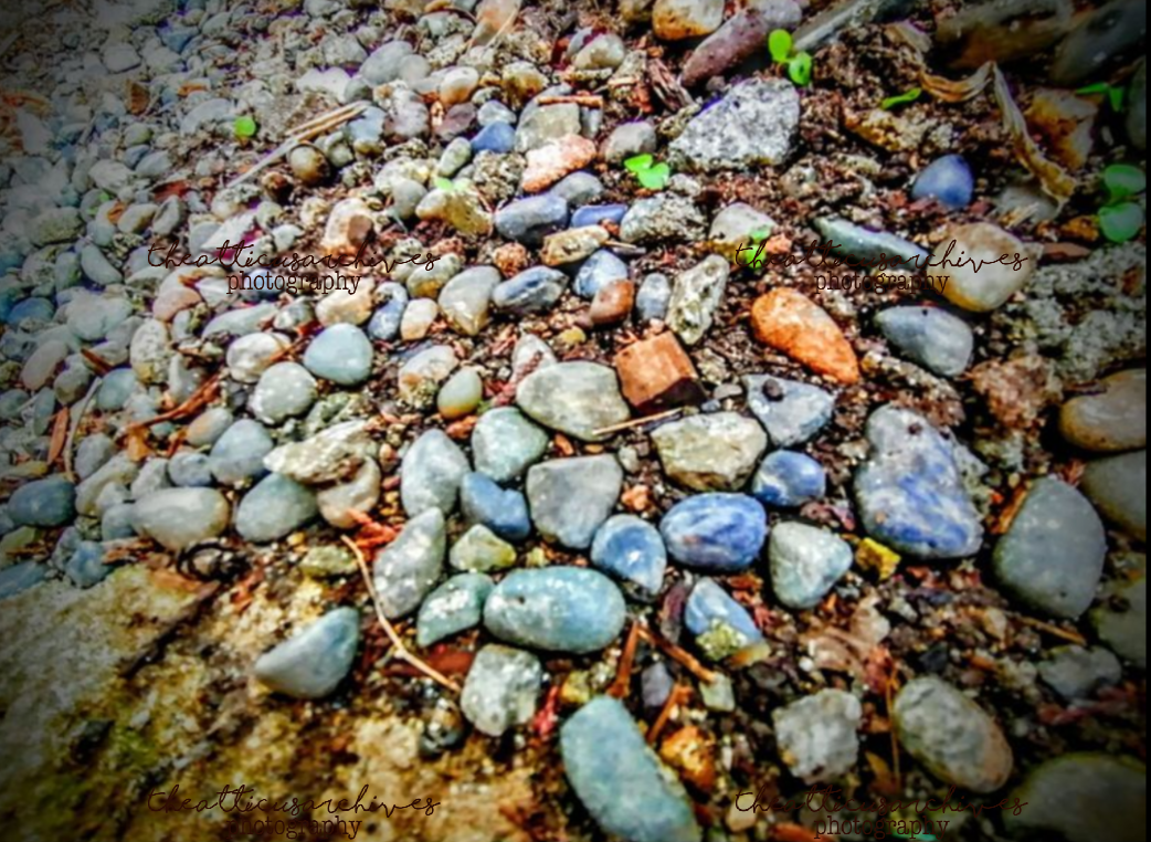 Smooth pebbles arranged or scattered, texture and color study, found-nature composition