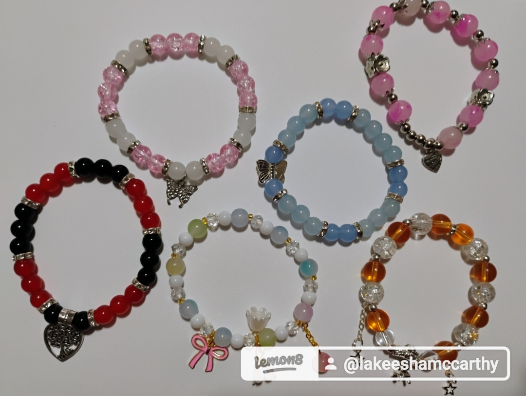 Colorful handmade bracelets with charms and sparkles