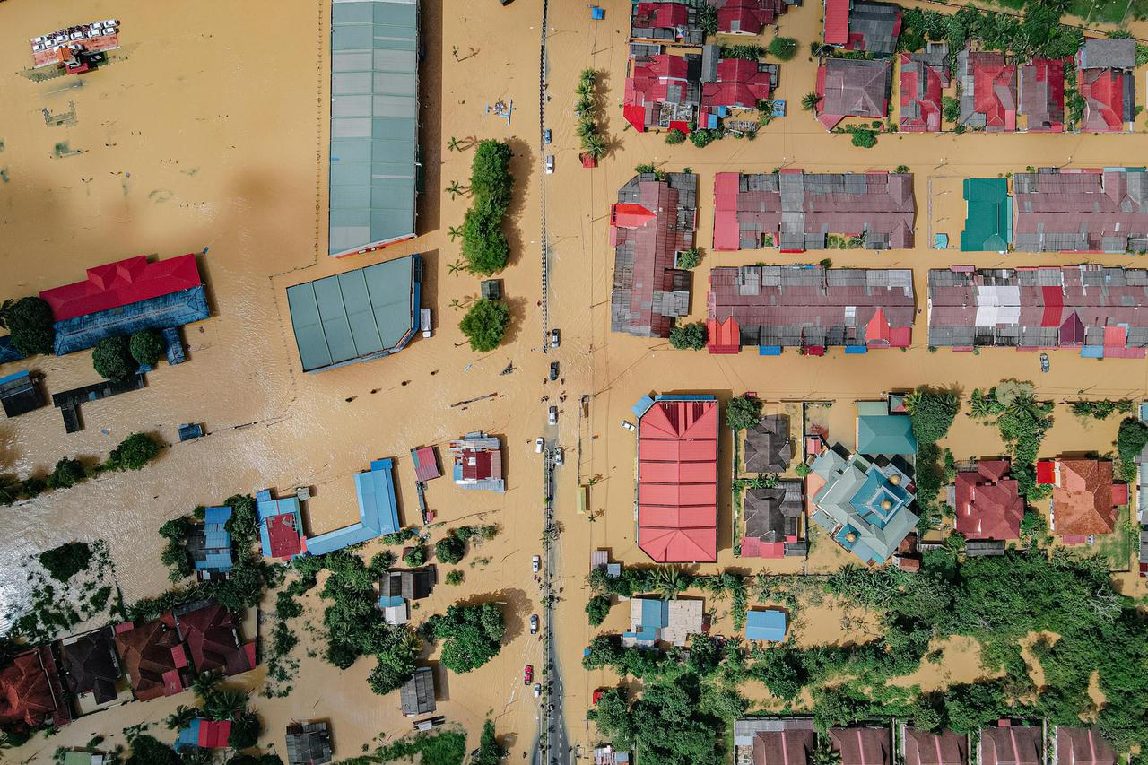 Aerial view of a flooded town showcasing buildings and streets submerged in water.
