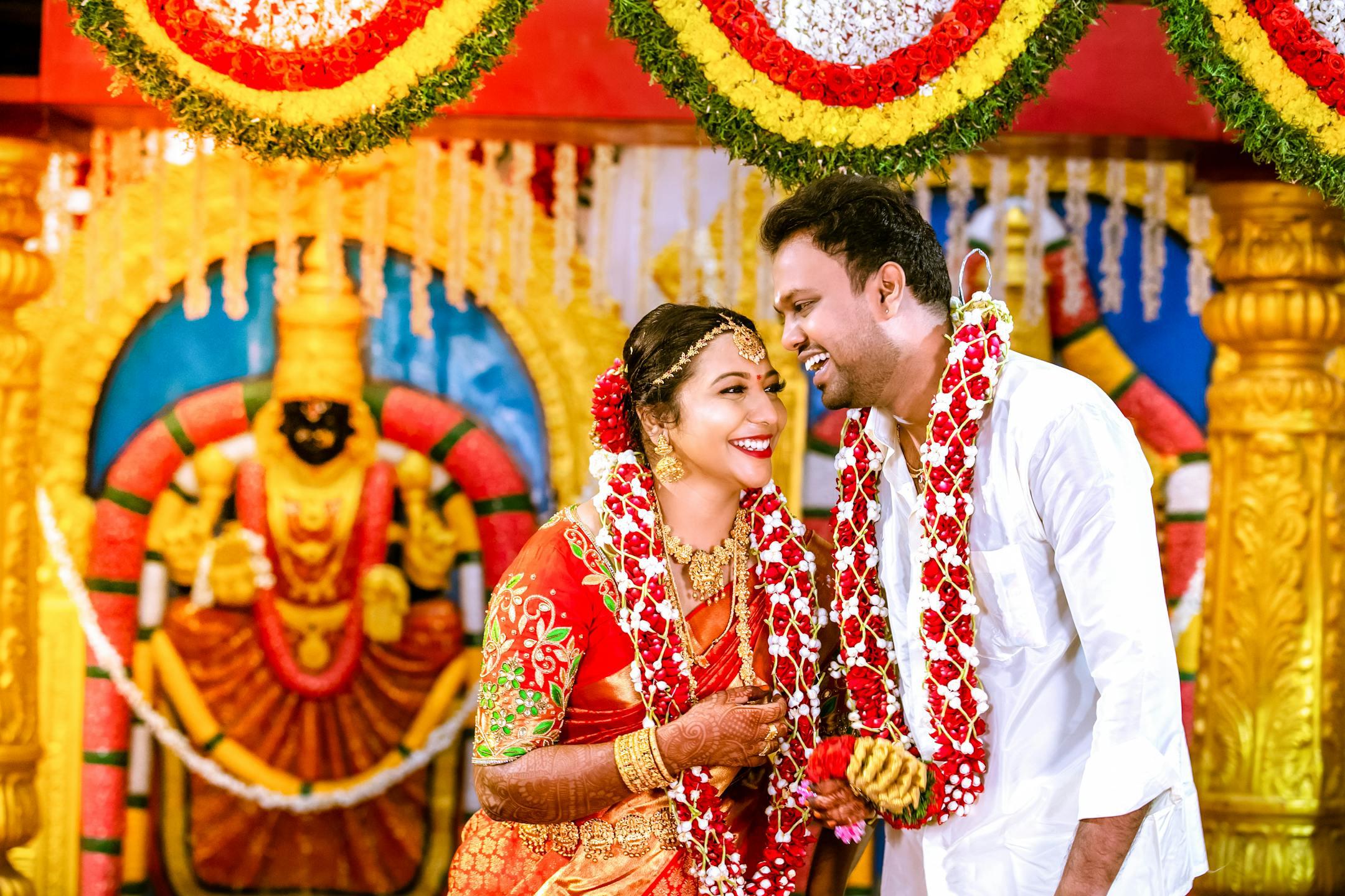 Happy South Indian couple in traditional attire during a wedding ceremony in Chennai.