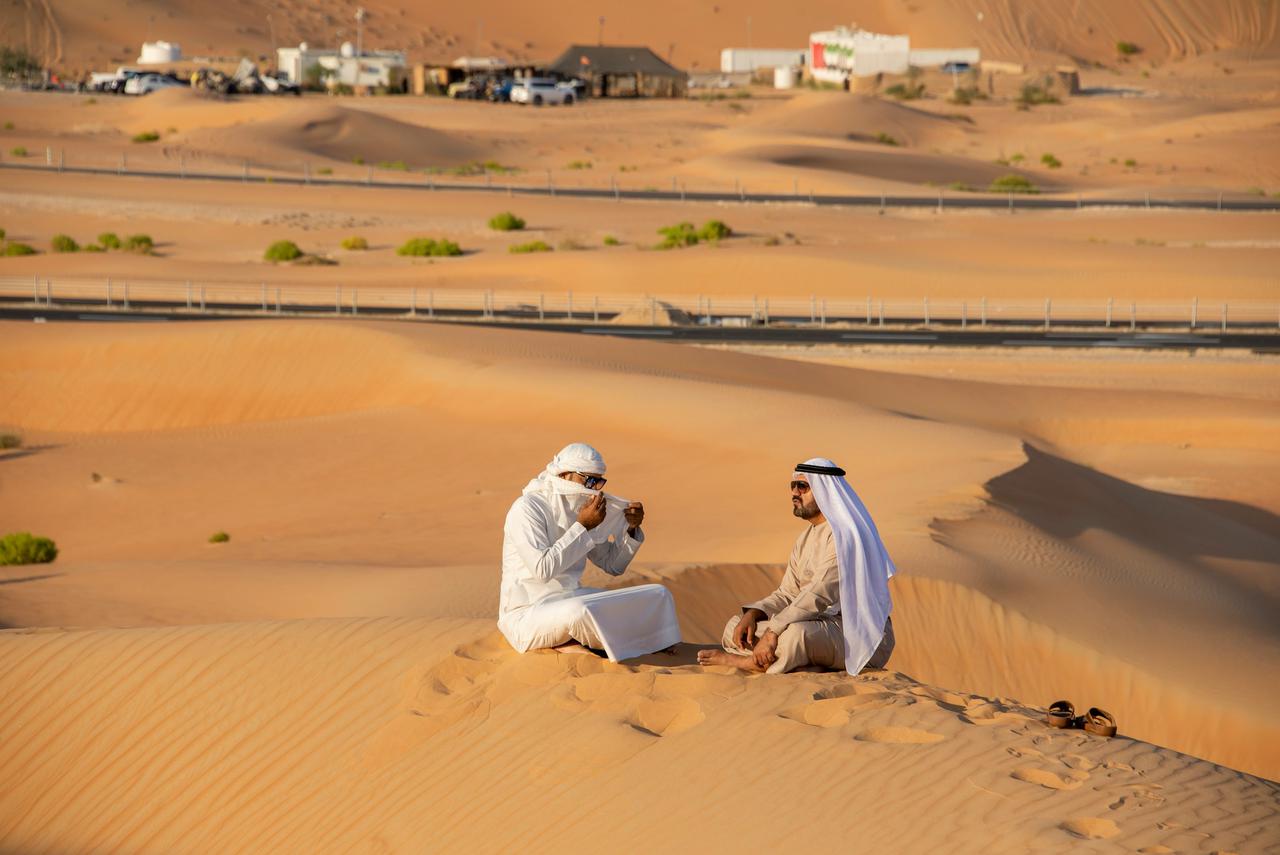 Two arab people sitting in the desert