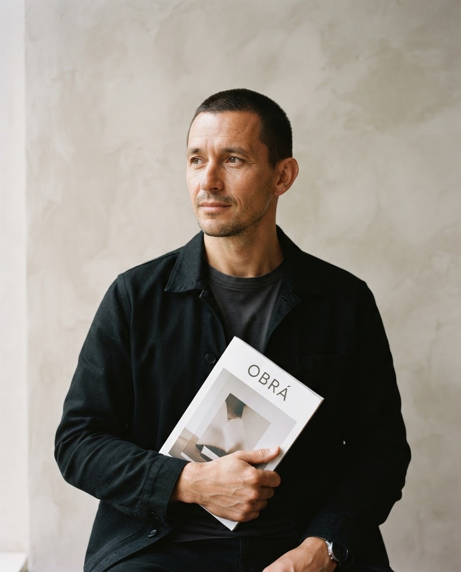 Marcus Bell, design director, in a thoughtful studio portrait against warm plaster