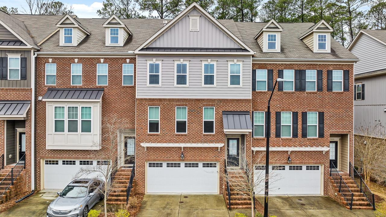 Discover charming brick townhouses with modern design in a peaceful suburban neighborhood.