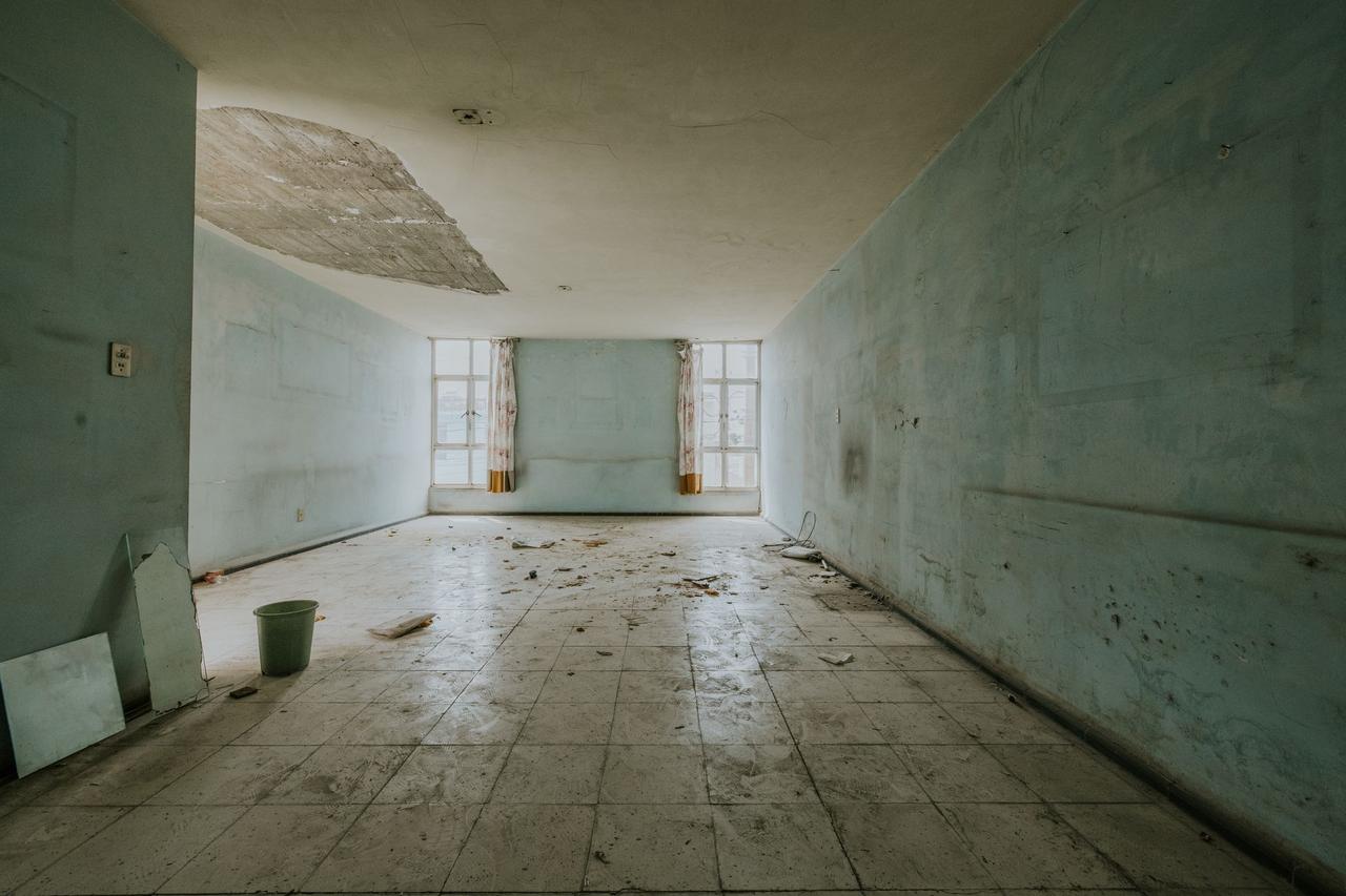 Room with water-damaged walls and ceiling