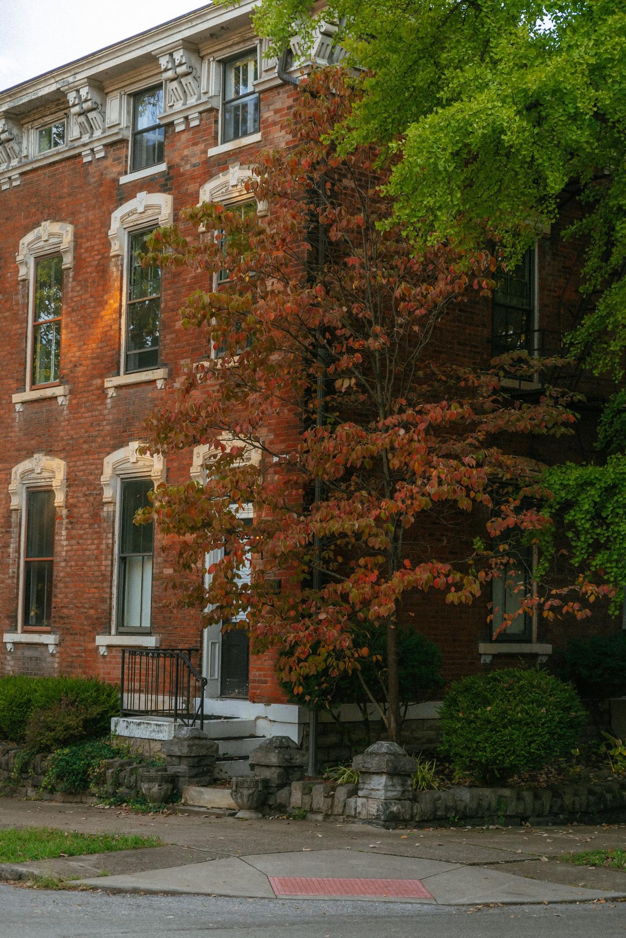 Charming historical brick building with autumn foliage in Covington, KY.