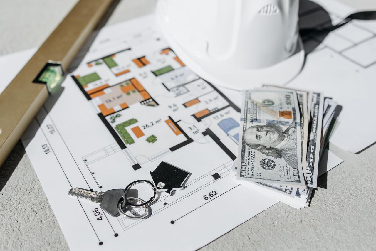 Cash and house plans on a table