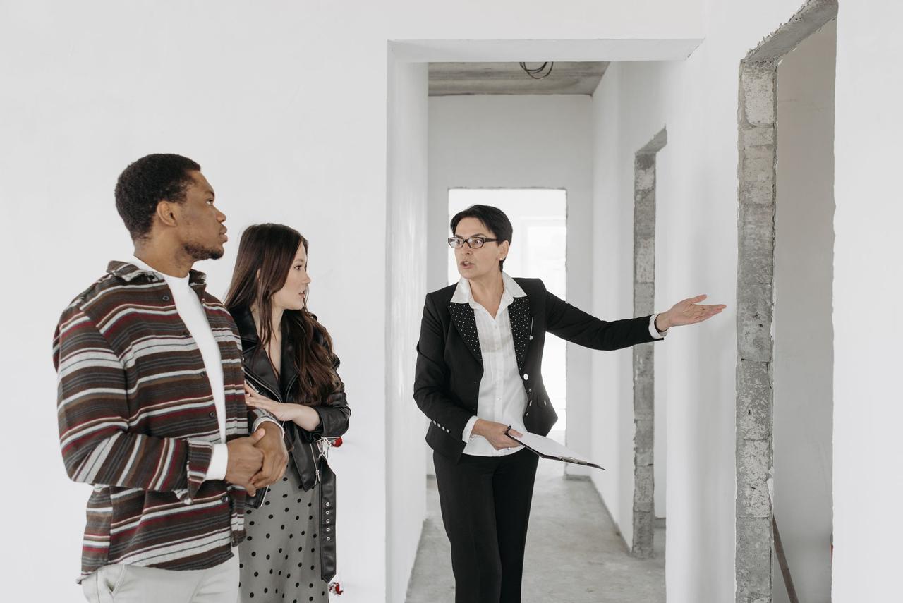 Real estate agent showing a house to buyers