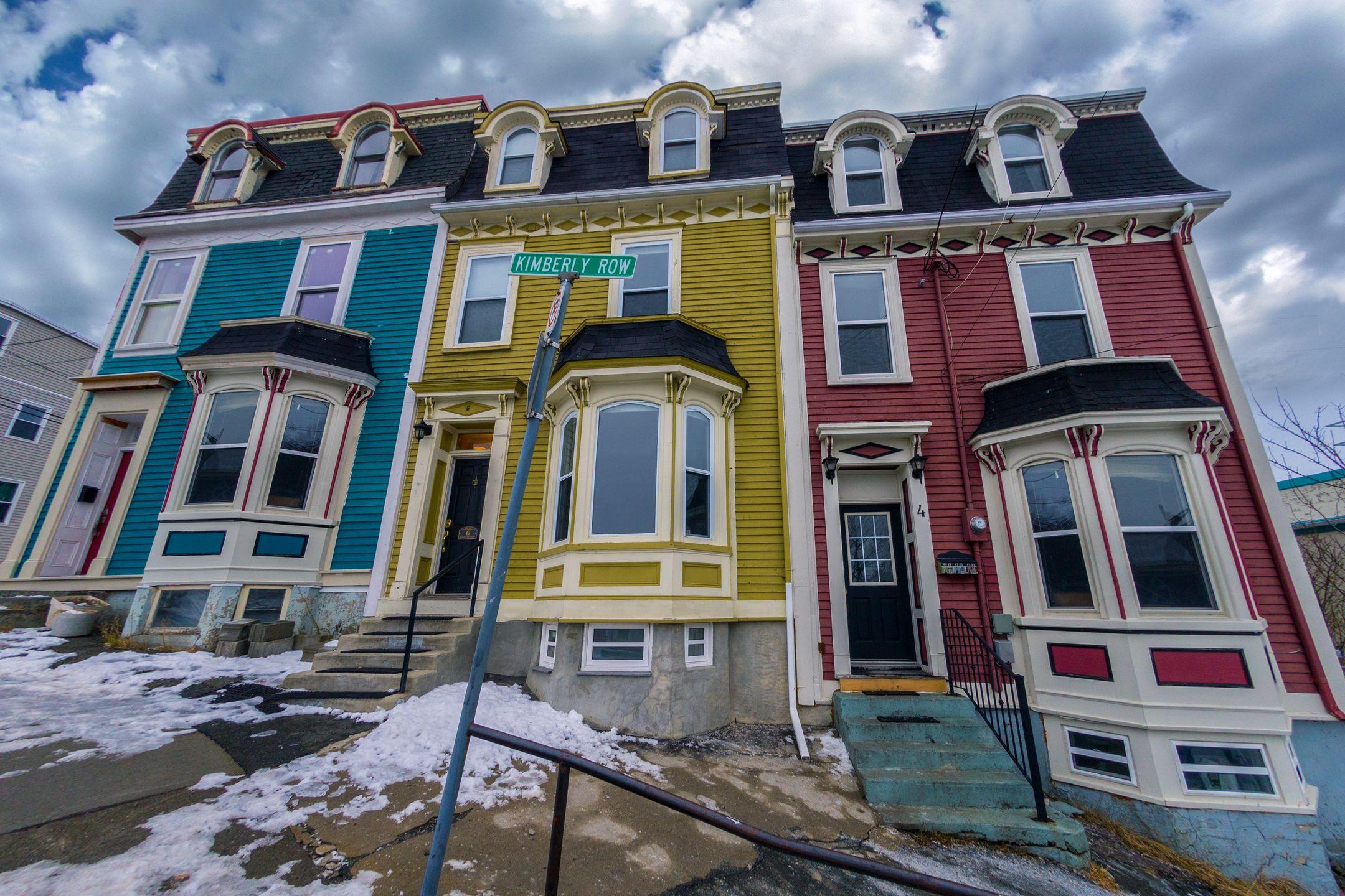 Low angle of bright residential building located on street of town in overcast winter day