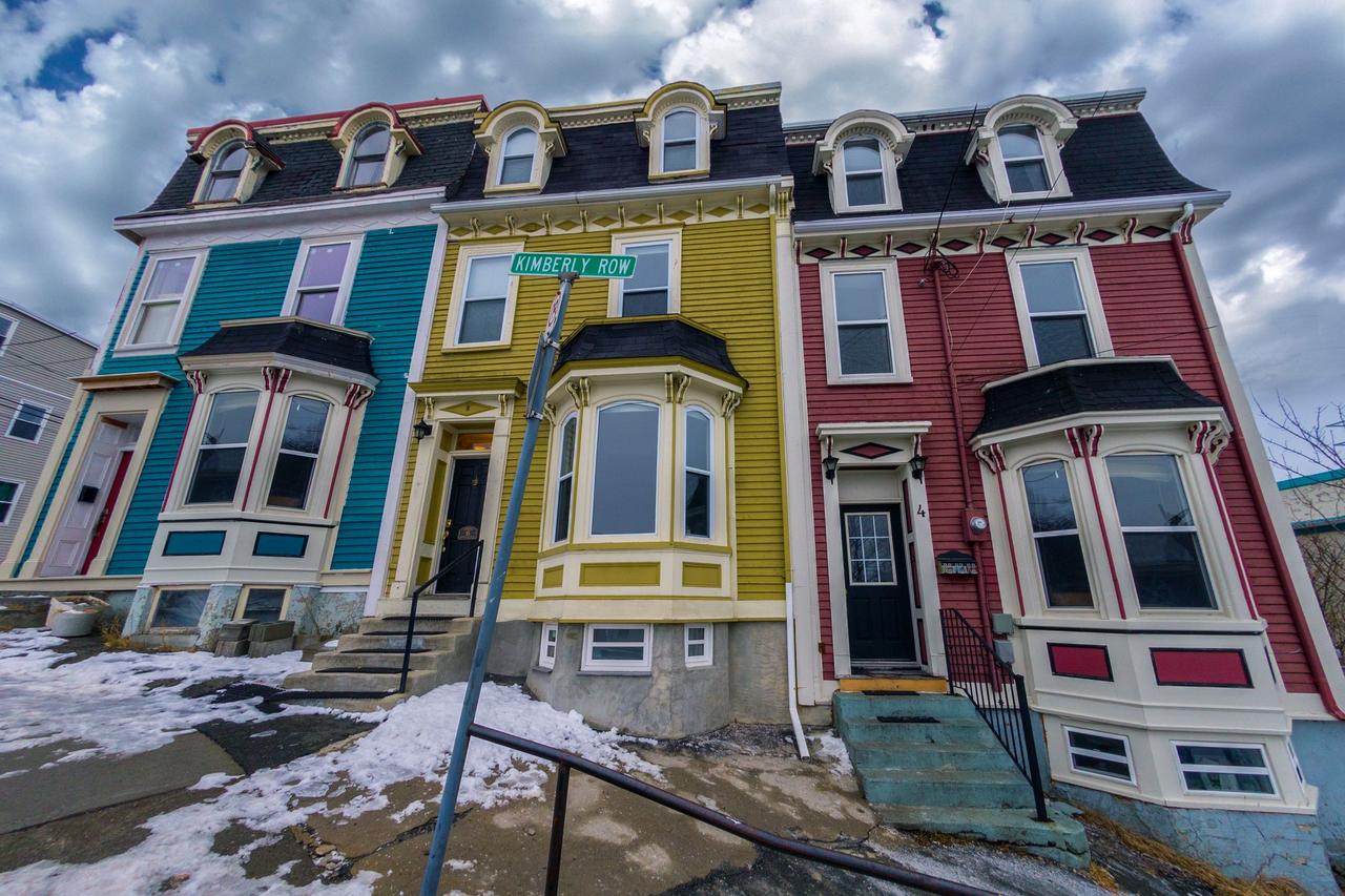 Low angle of bright residential building located on street of town in overcast winter day