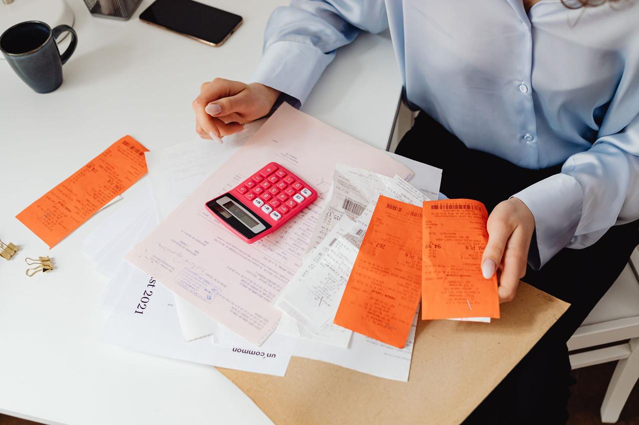 Hands reviewing medical bills with a calculator