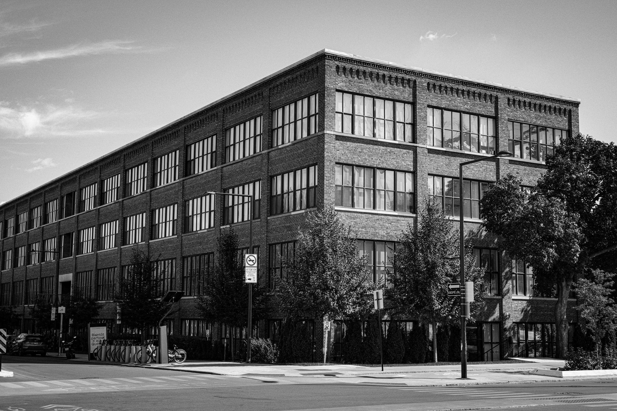 A black and white view of a historic urban building in Montreal, showcasing its architecture.