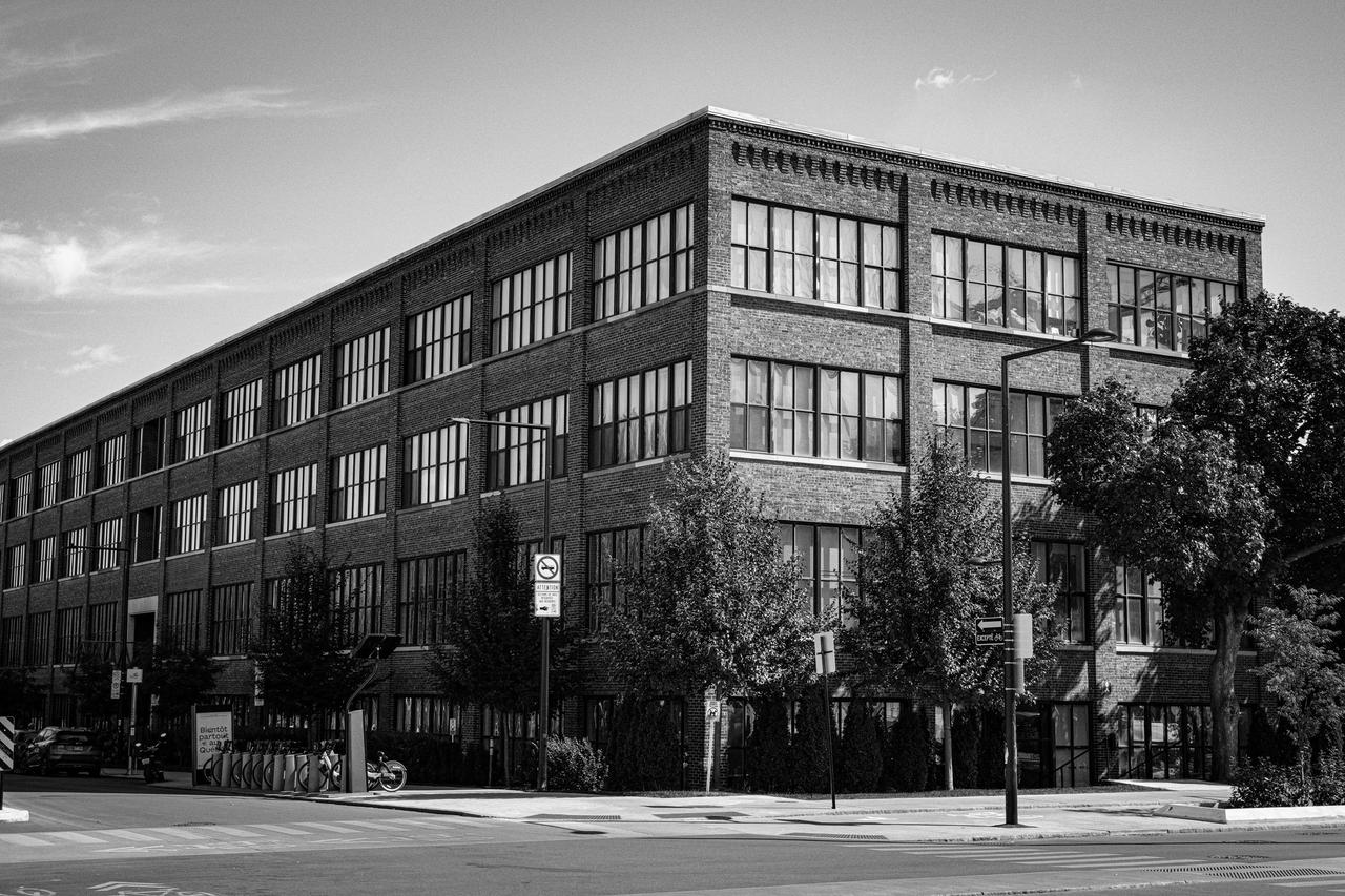 A black and white view of a historic urban building in Montreal, showcasing its architecture.