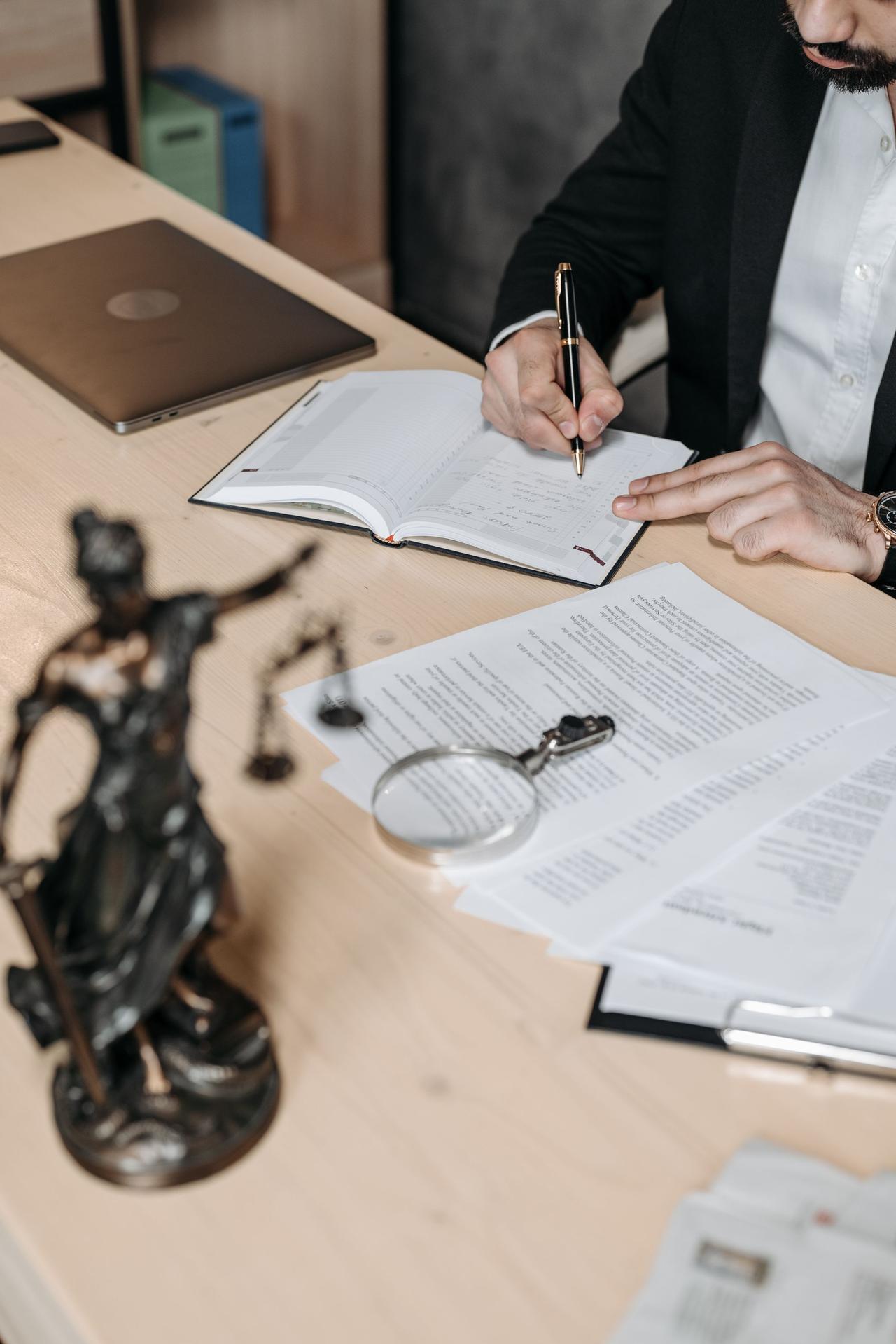 Attorney's desk with legal documents and scales of justice