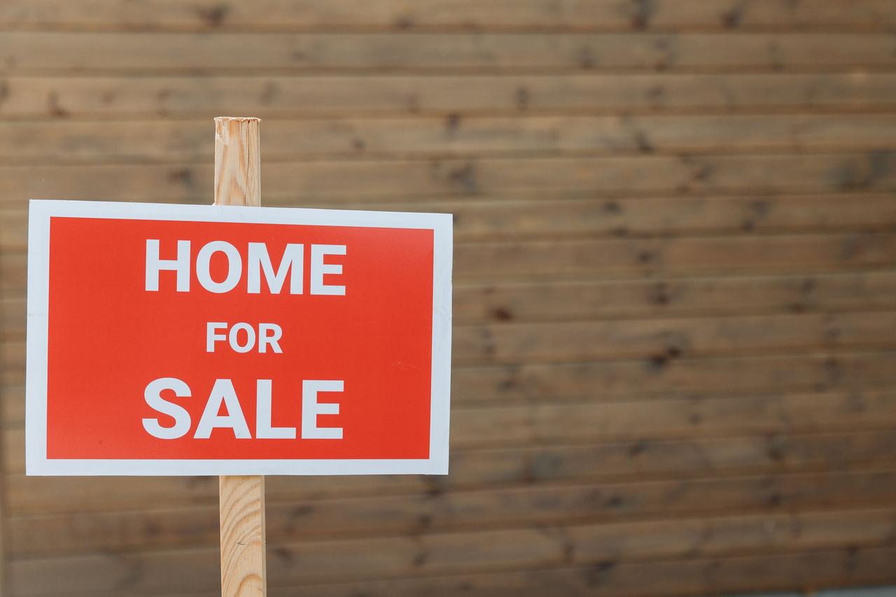 Home for sale sign in a front yard