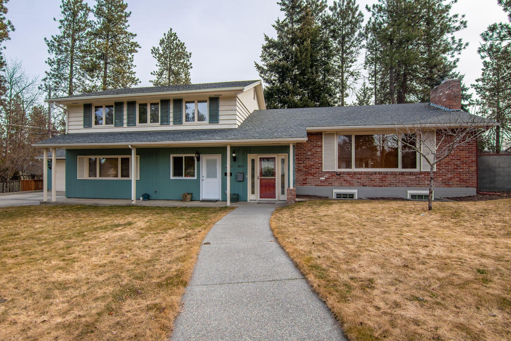Front view of a suburban home with a large lawn, ideal for families.
