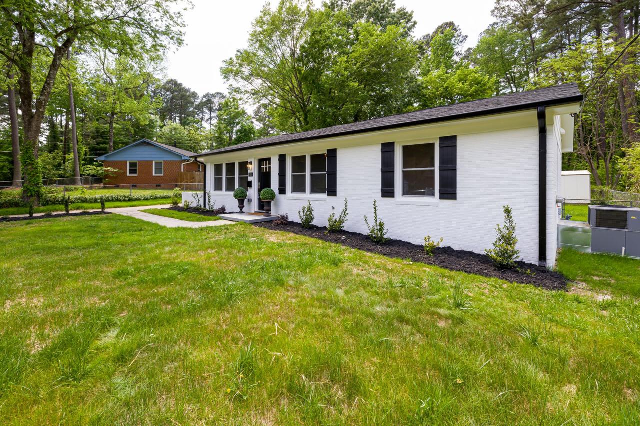 Single-story ranch house with a green lawn
