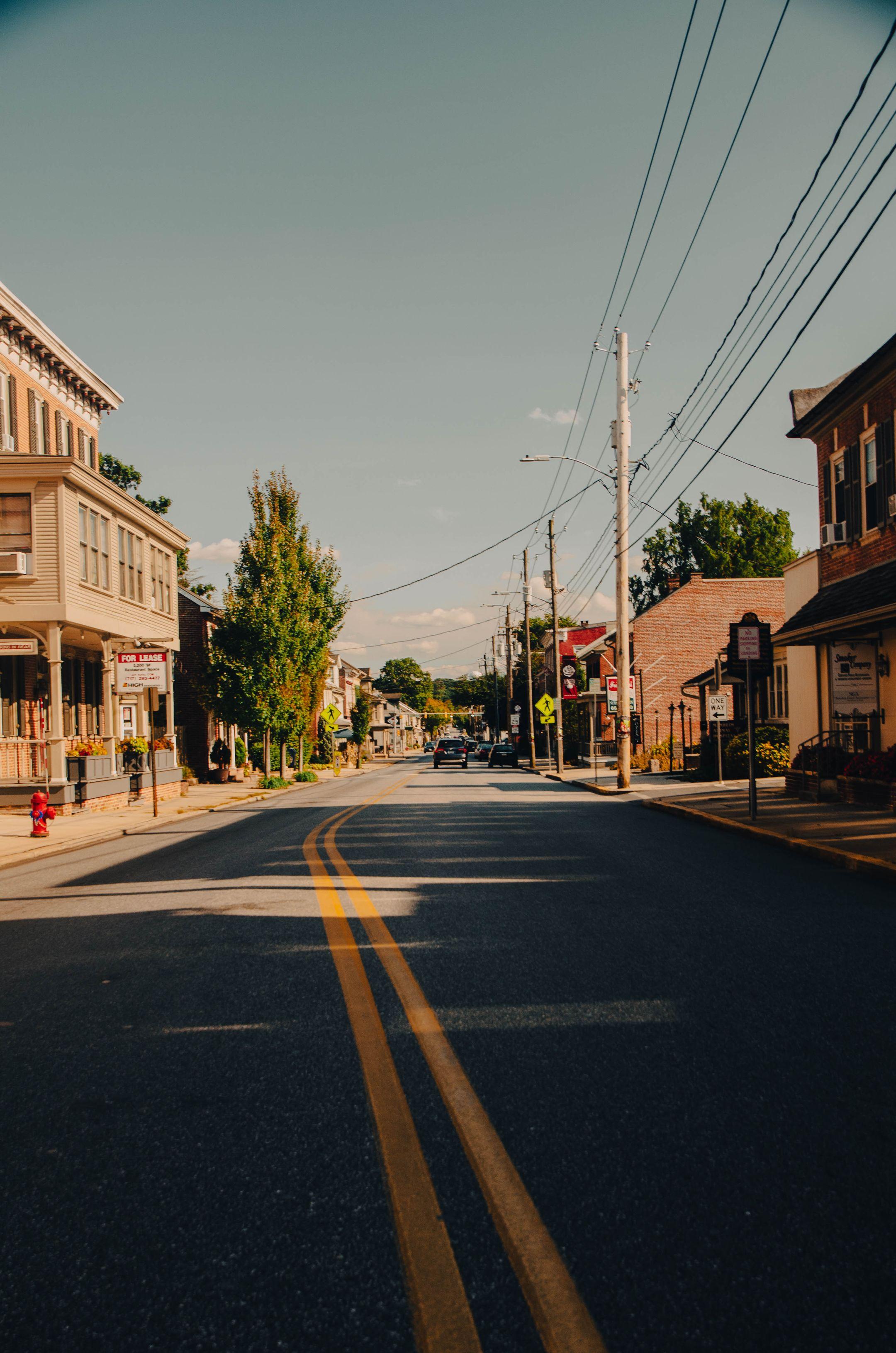 Picturesque view of a quiet street in Manheim, PA with historic buildings and clear sky.