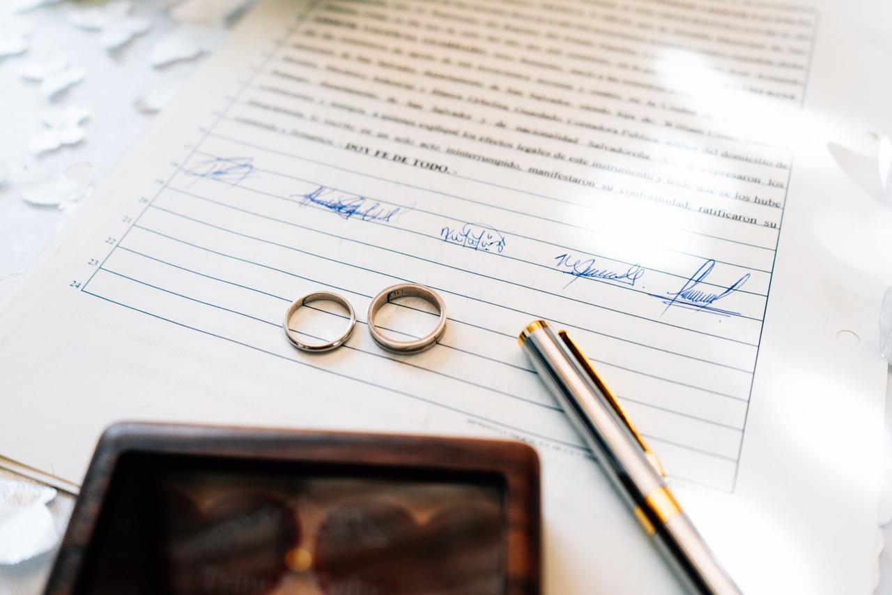 Wedding rings resting on legal documents