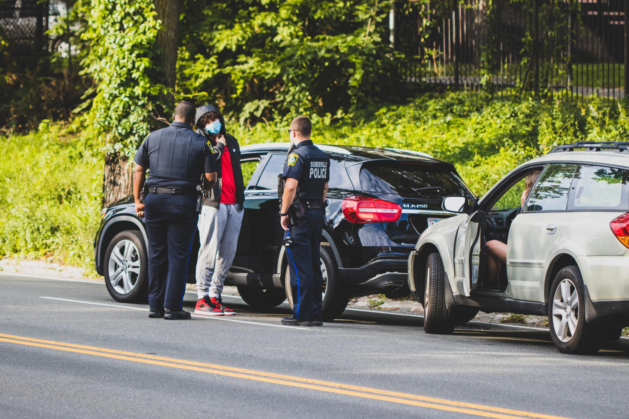 Police talking to a driver after an accident.