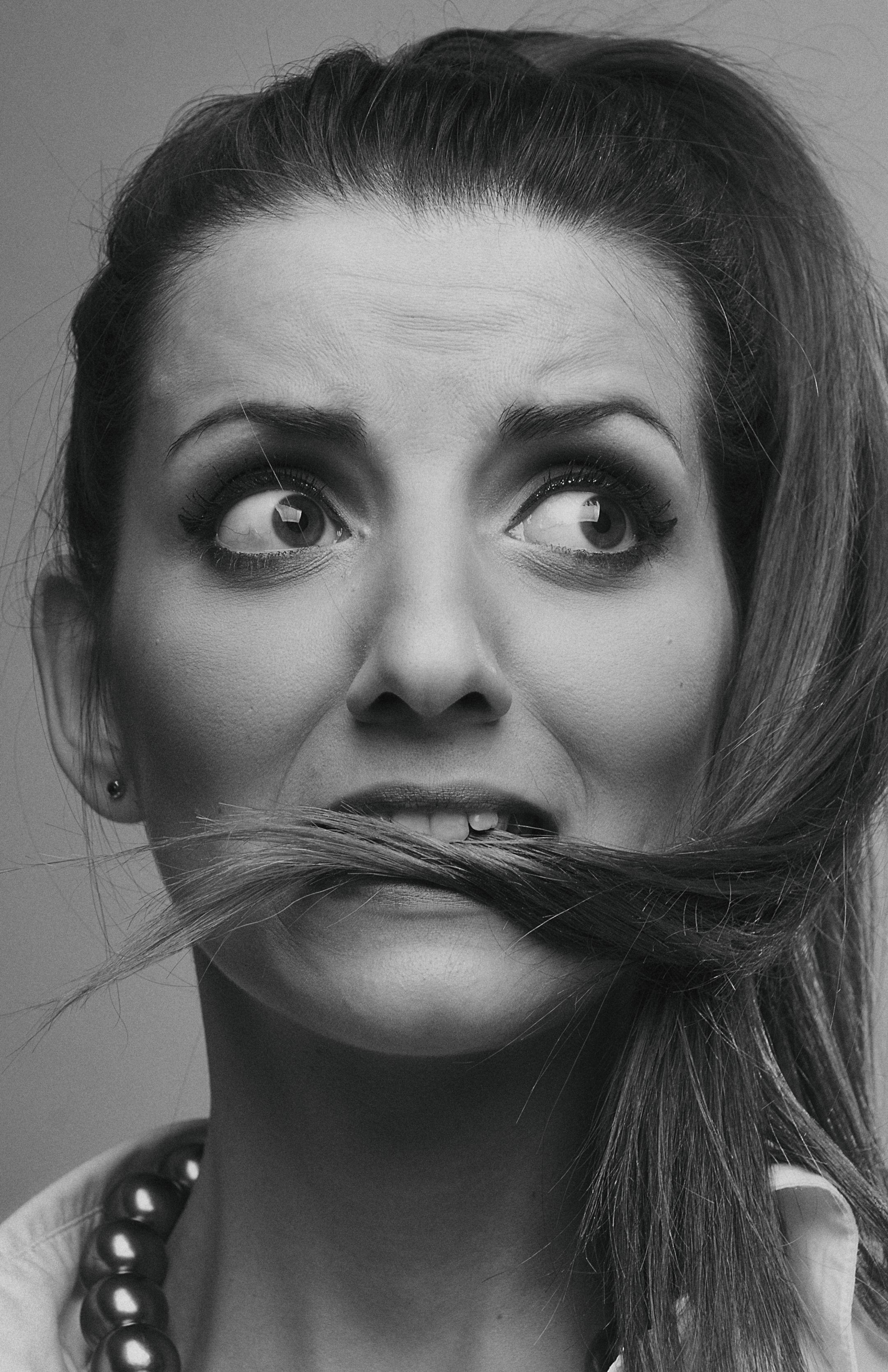 Artistic black and white portrait of a woman displaying a worried expression.