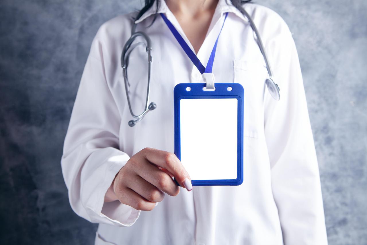 A woman with a tablet around her neck.