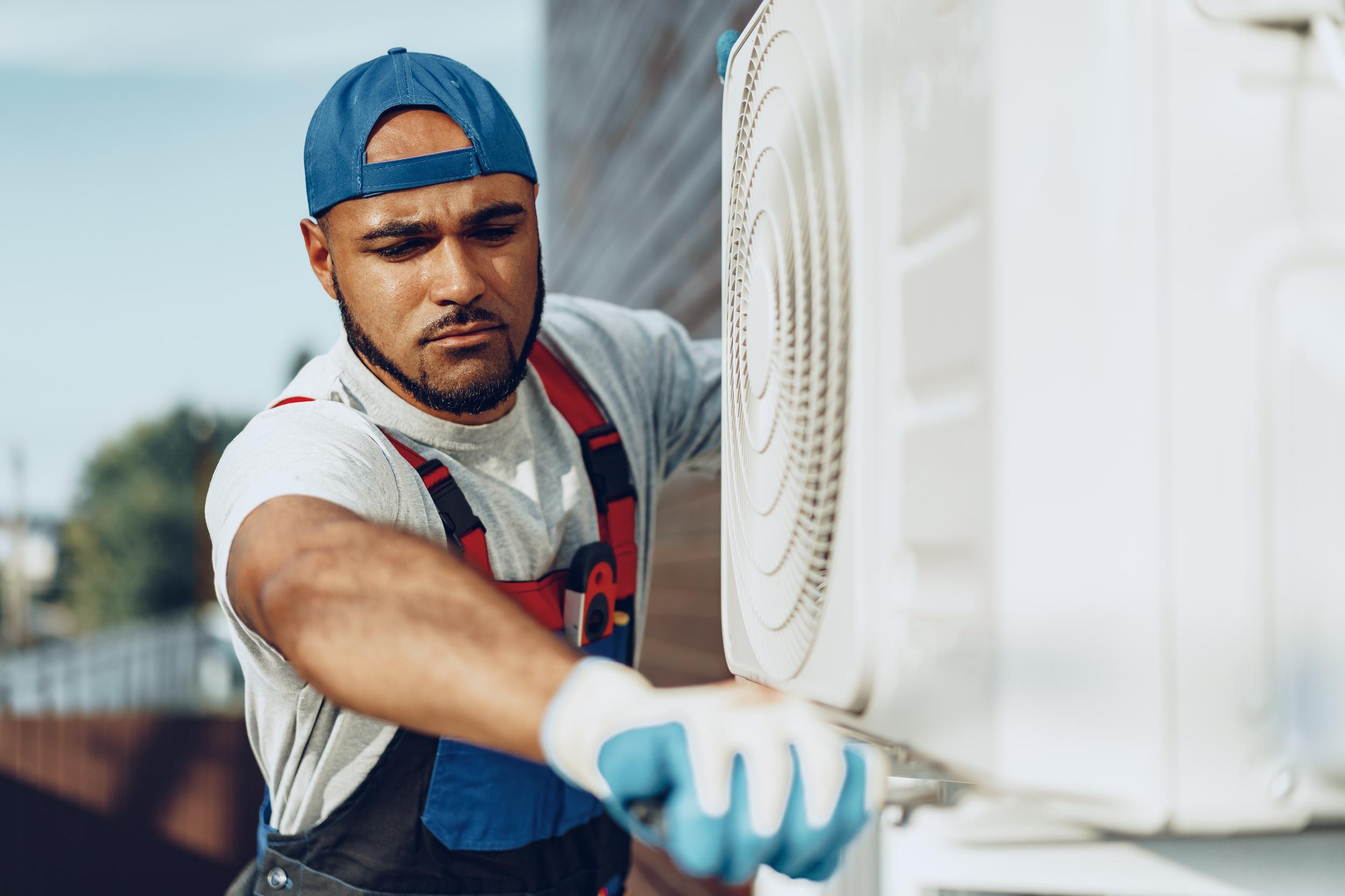 young-black-man-repairman-checking-an-outside-air-2026-01-08-06-04-41-utc.jpg