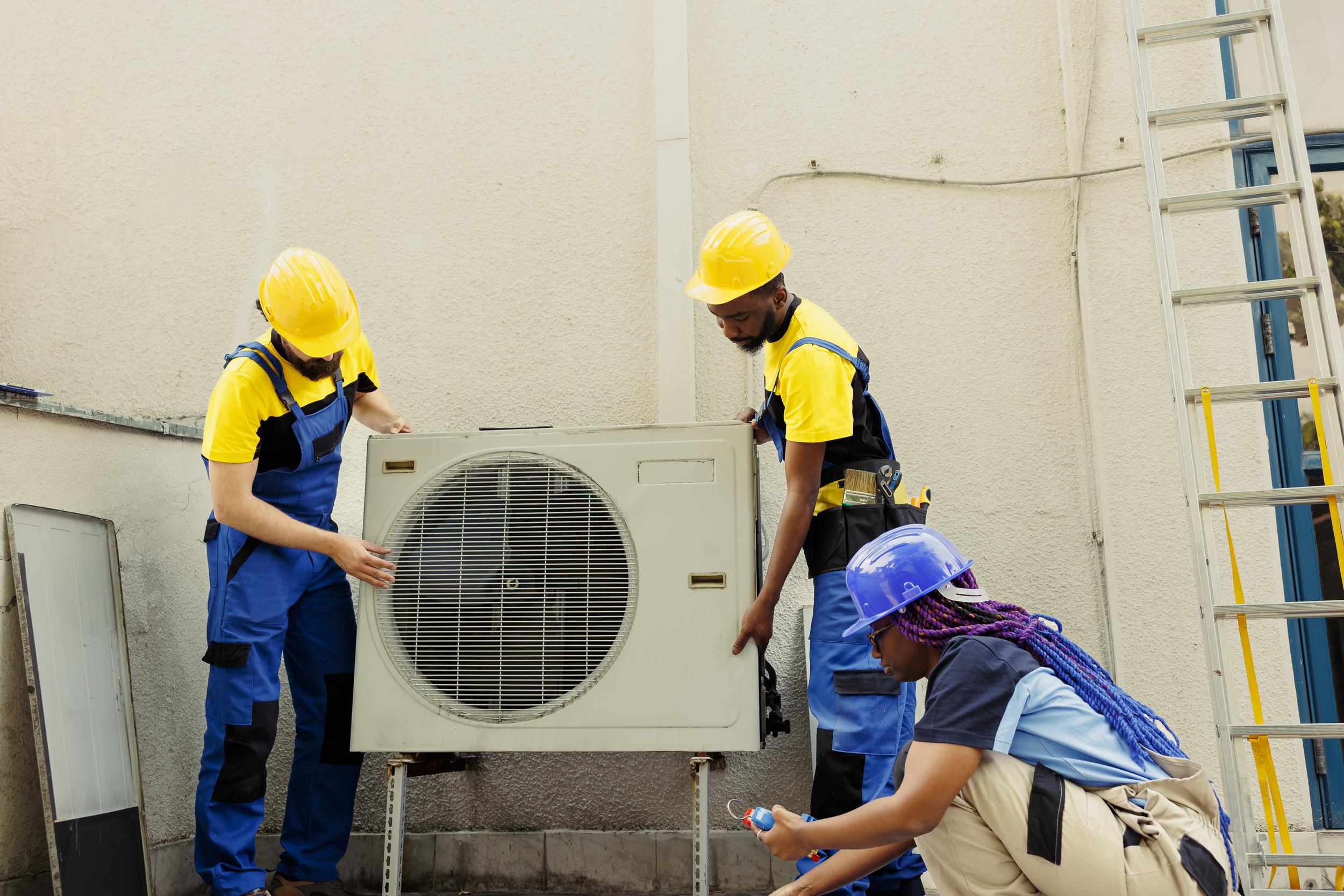 workers-putting-air-conditioner-in-place-2026-01-08-02-30-05-utc.jpg