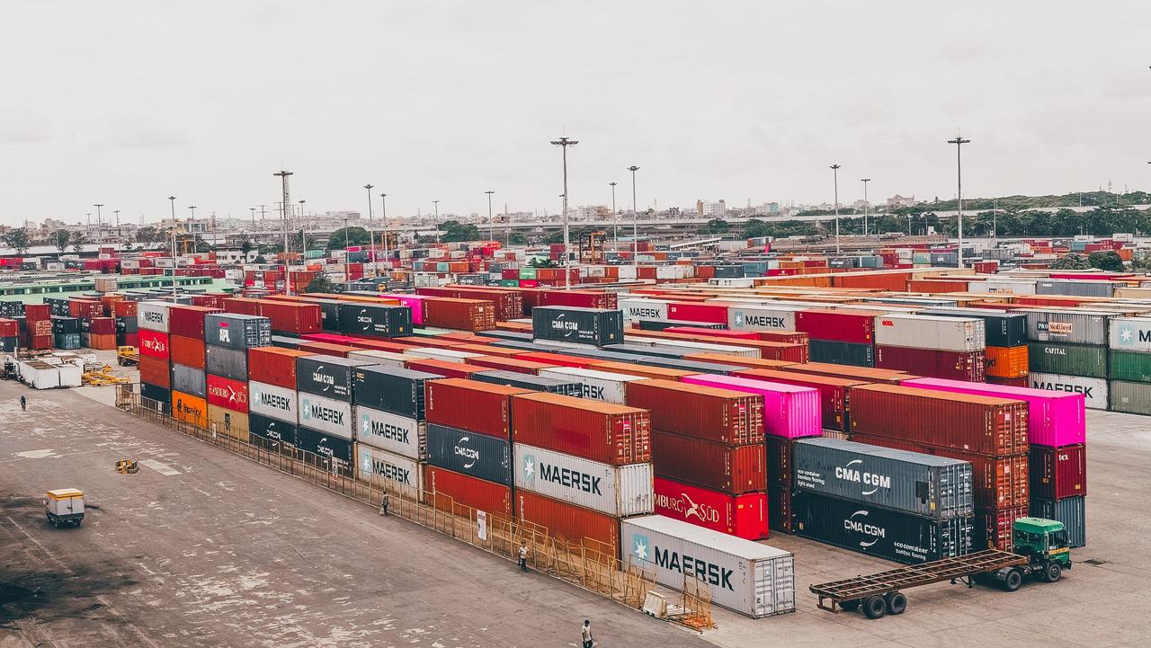 Colorful shipping containers stacked at a bustling port showcasing global trade.