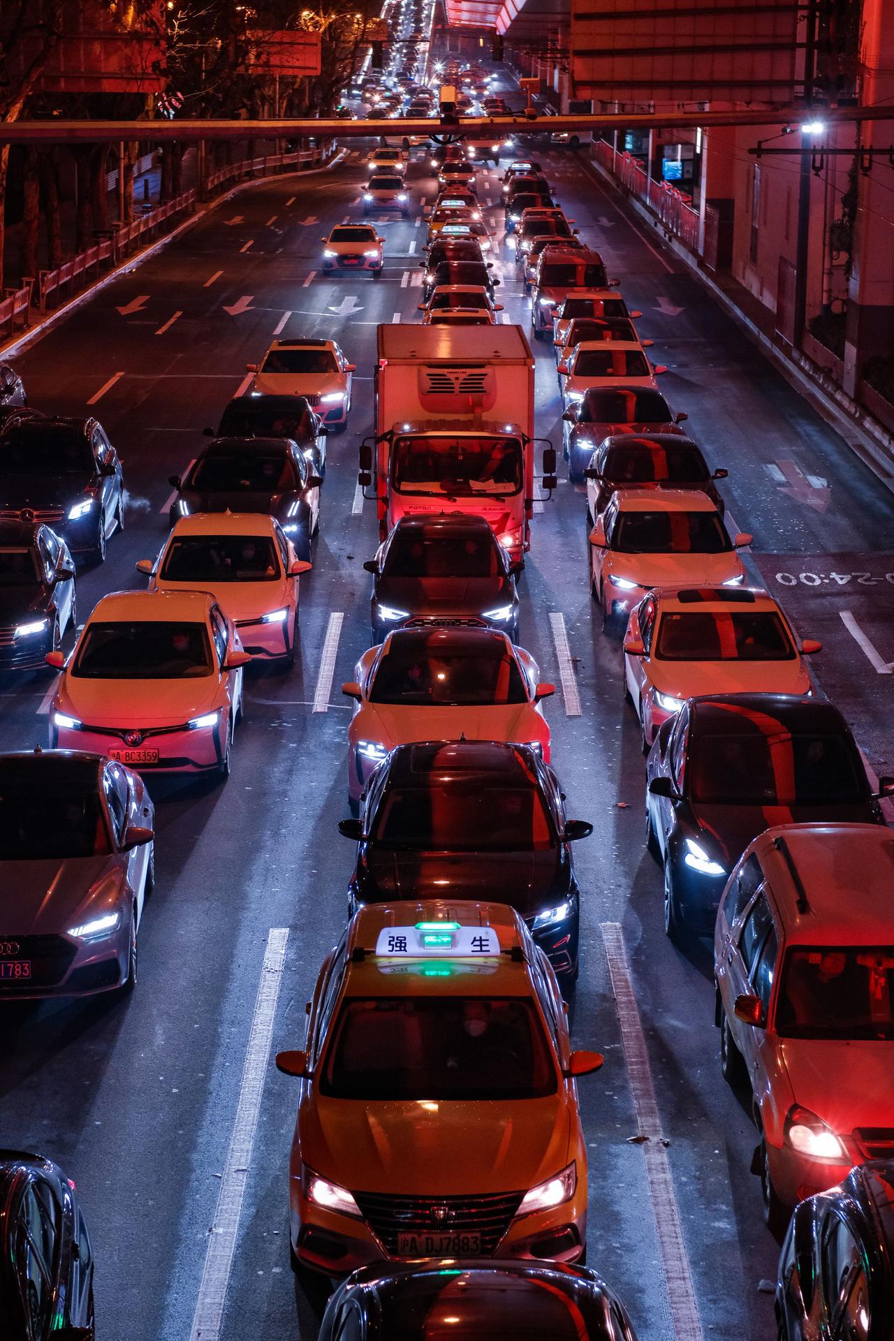 Aerial view of a busy night traffic jam in a vibrant urban setting.