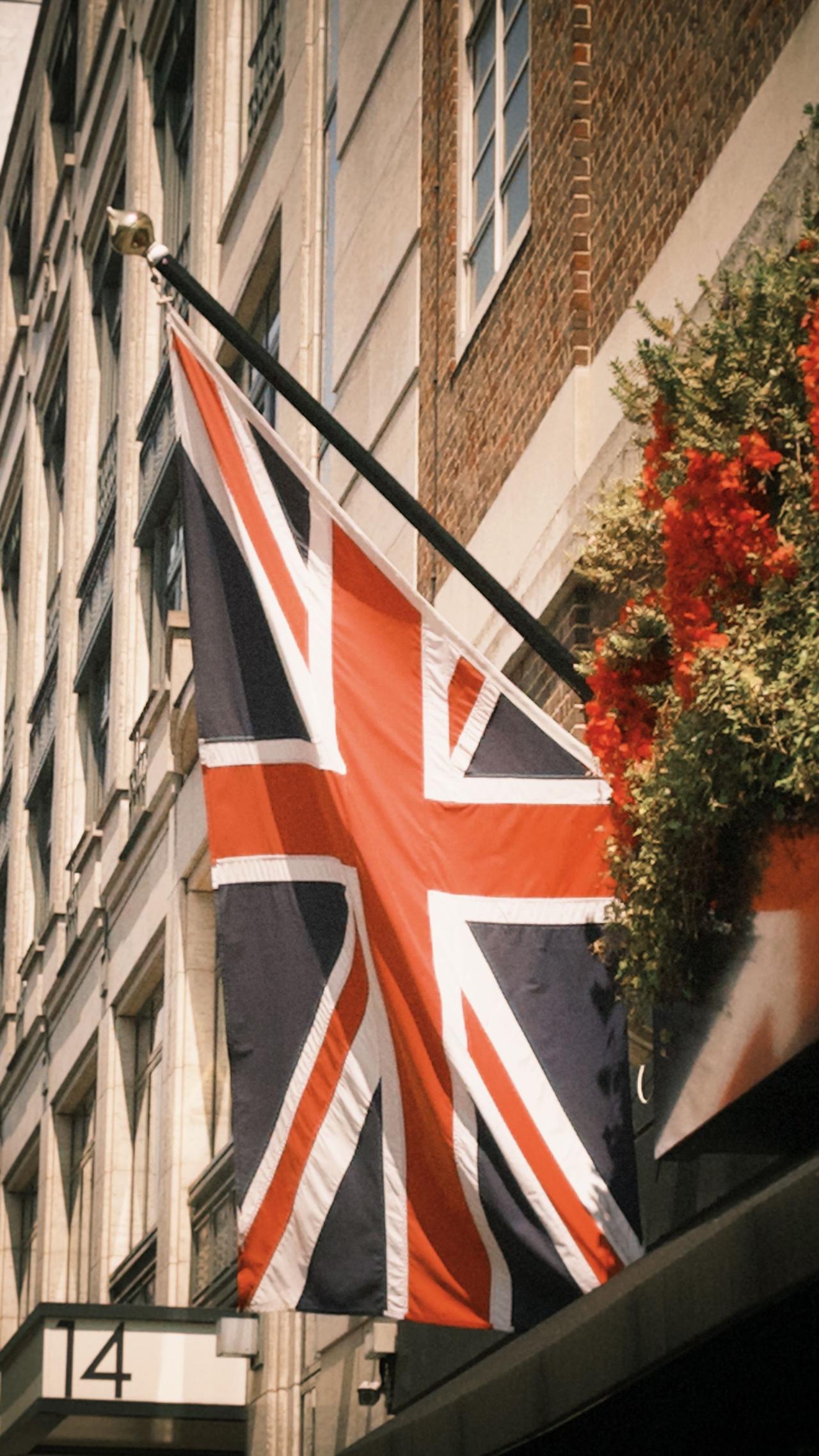 Union Jack flag on a building in a city street in daylight